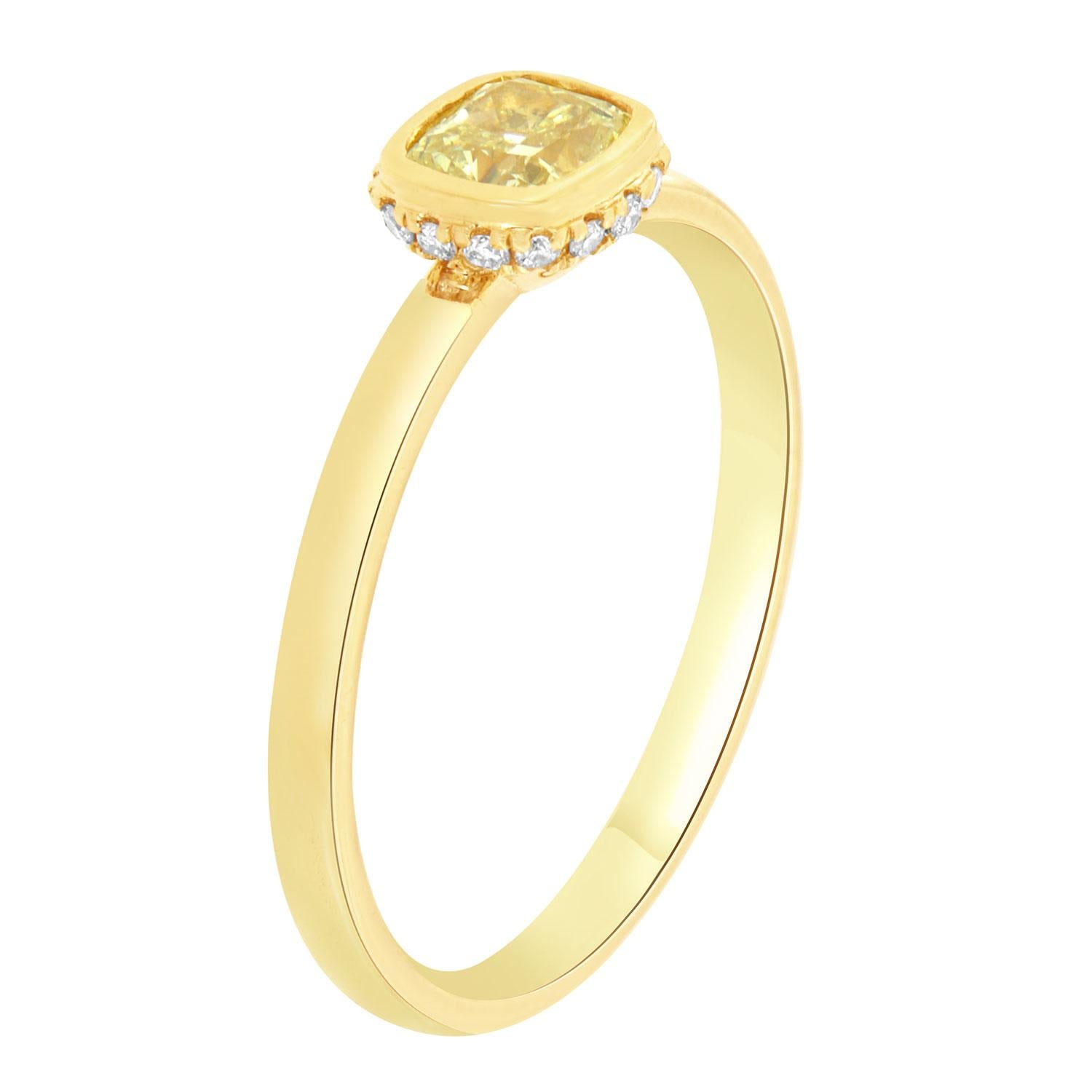 This beautiful 18K yellow gold ring features a 0.52 Carat Elongated Cushion-shaped Natural Yellow Diamond bezel set. A hidden halo of brilliant round diamonds encircled the crown on top of a 1.9 mm wide band. 
The yellow diamond is certified by EGL