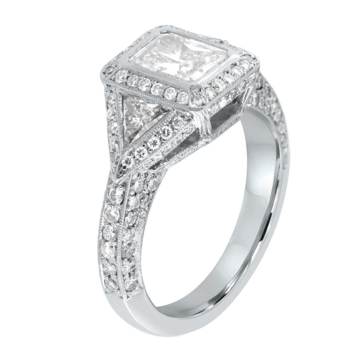 This Pre-Owend Platinum handcrafted Women's trilogy ring showcases an EGL Certified 1.03 Carat Radiant Cut natural diamond accompanied by two (2) Trillion Cut diamonds on each side, along with a melee of Round Brilliant diamonds on an elegant