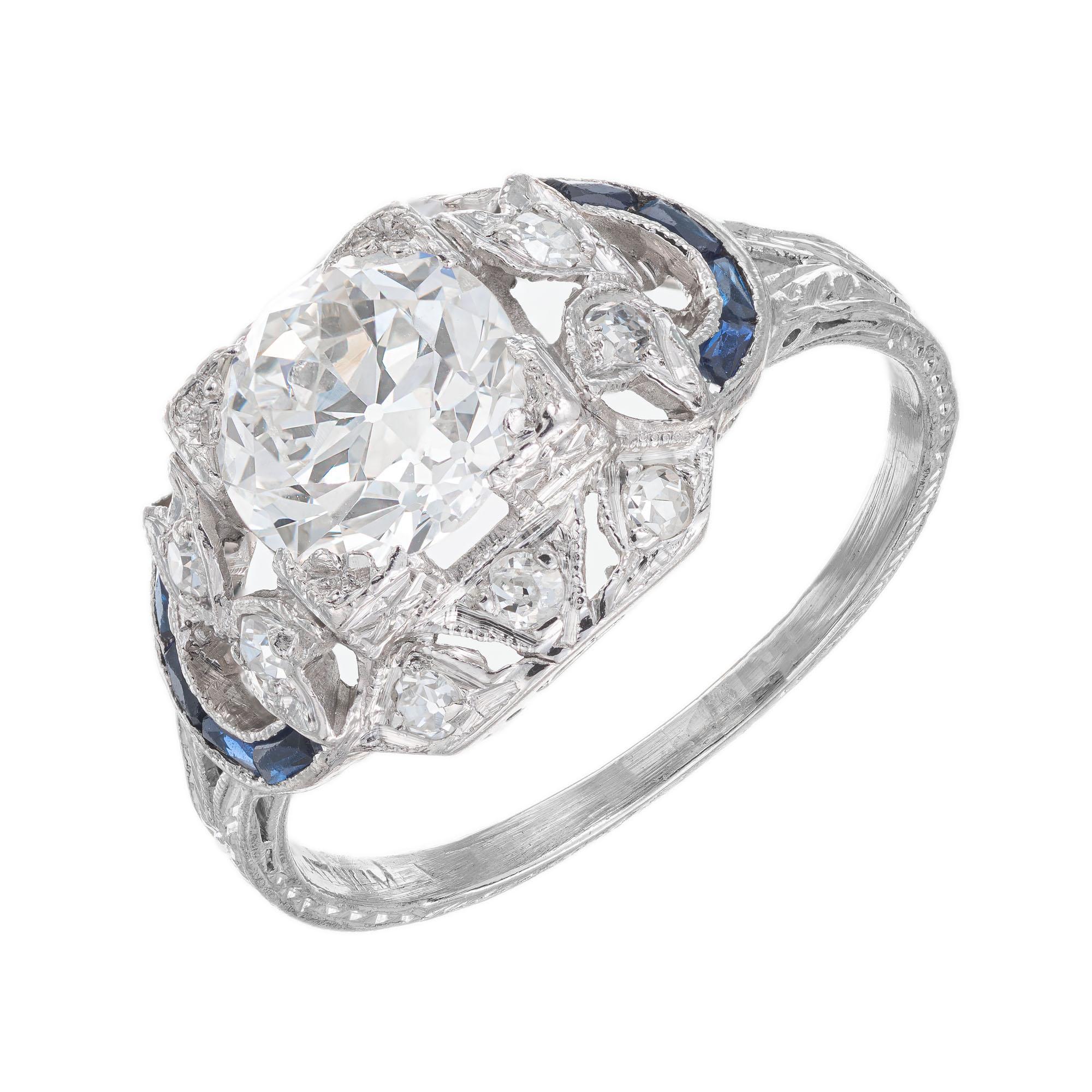 Edwardian Art Deco 1930's diamond and sapphire engagement ring. 1 round transitional brilliant cut center diamonds with 8 baguette cut sapphires and 10 single round cut accent diamonds, in a platinum hand pierced and engraved setting. EGL certified.