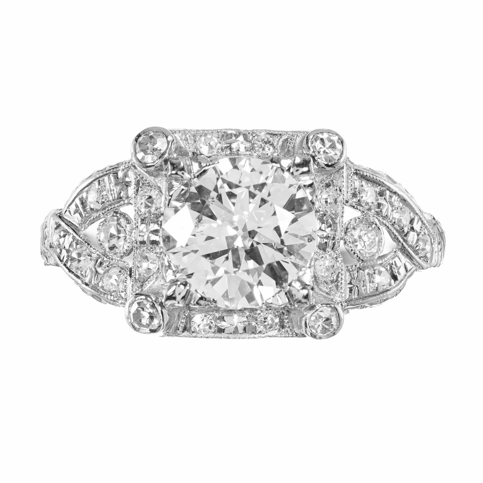 This 1.35 carat transitional cut diamond is centered into a handmade open work platinum setting with 22 single cut diamonds surrounding the center in an intricate and beautifully positioned way. Circa 1960. Certified by the EGL as near colorless.