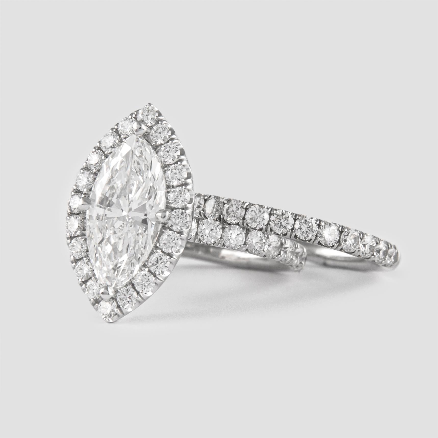 Stunning and classic diamond halo engagement ring with a half-way eternity band, EGL certified.
Center stone, 2.11ct marquise cut diamond. E color grade & VVS2 clarity grade, EGL certified. Side stones, 52 round brilliant diamonds, approximately F/G