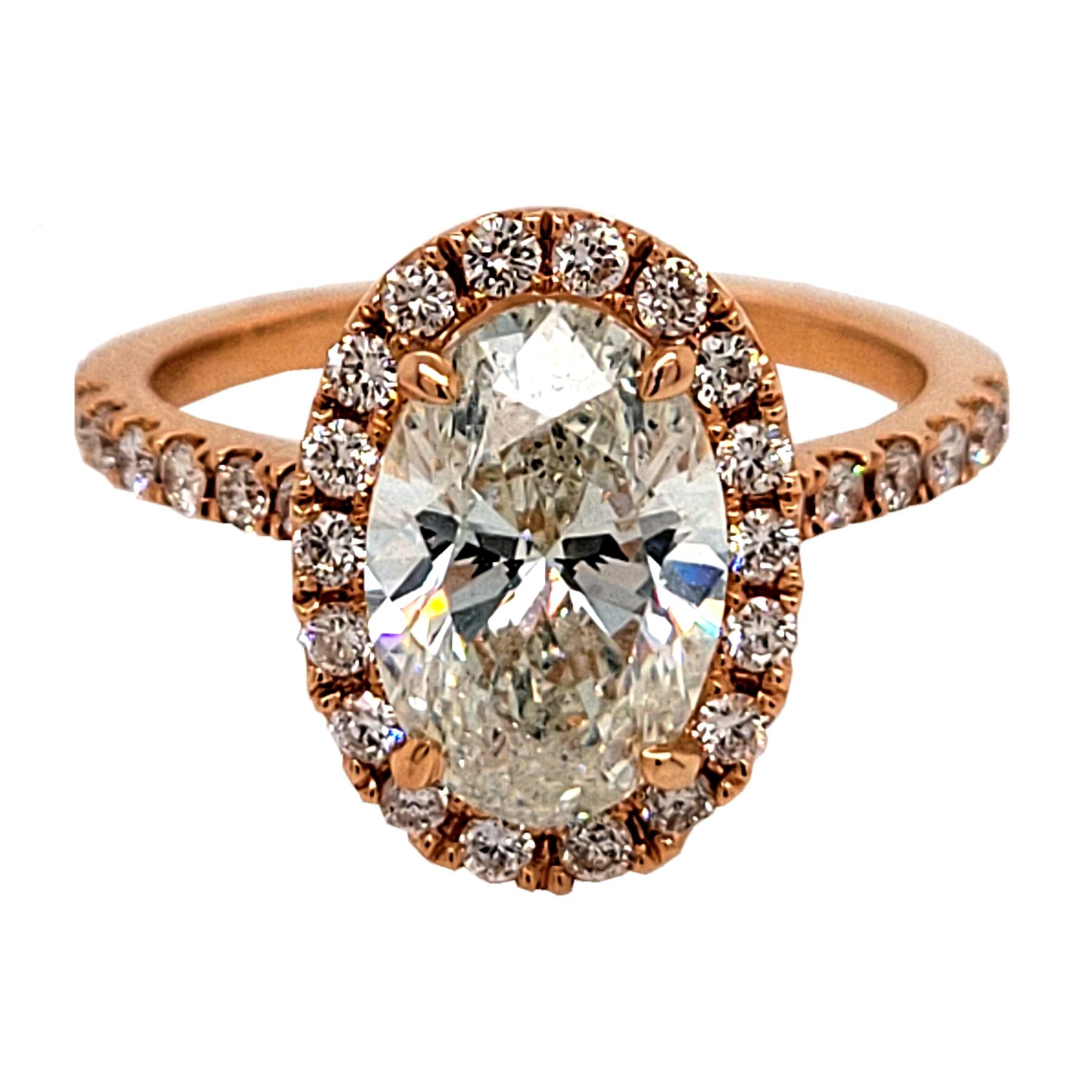 A very fine Oval Shape J/SI1 EGL certified center Diamond set in a fine 18k gold pave set Engagement Ring with Halo and total weight of 0.58 Ct diamonds on the side. 

Diamond specs:
Center stone: 2.20 Ct EGL Certified J/SI1 Oval Shape natural