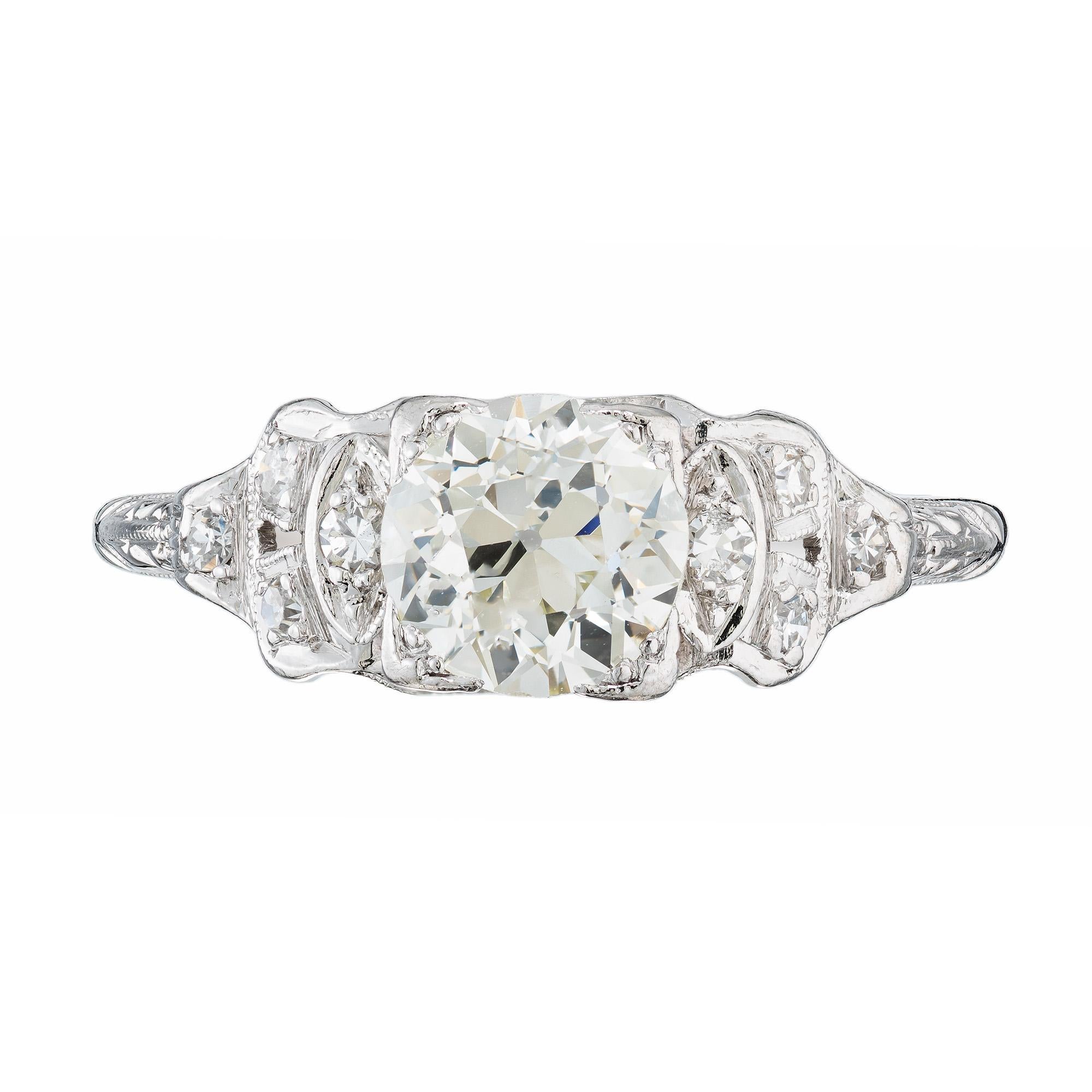 Immerse yourself in the timeless allure of an era gone by with our Art Deco 1920’s Platinum diamond engagement ring. The center is set with a .91ct old European cut center diamond that faces up white with a raised crown and small table. Accented by