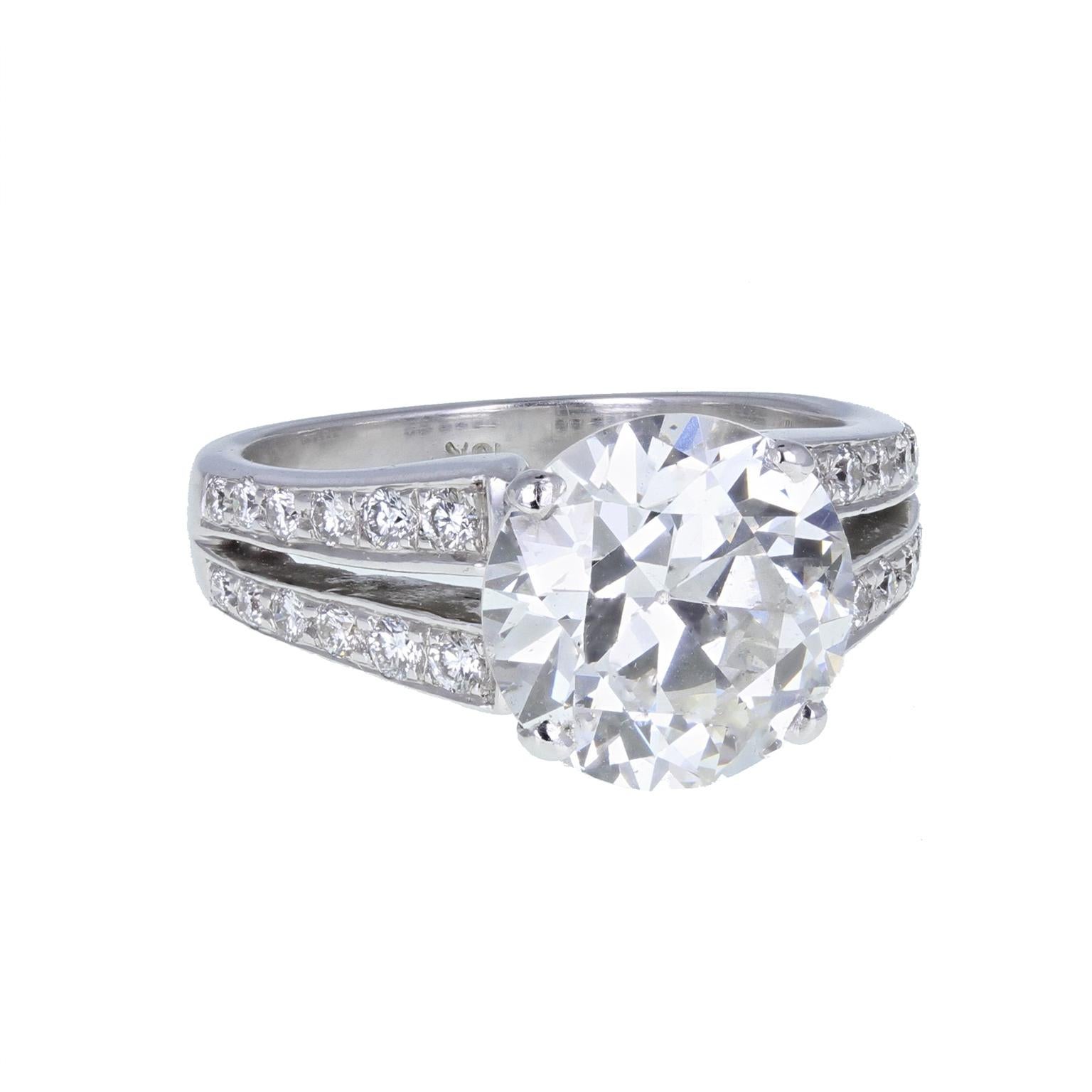 The exceptional round brilliant-cut diamond of 4.20 carats, F colour SI3 clarity is mounted in four claws, full of sparkle and scintillation. The split shoulders are set with melee diamonds to accent the principal diamond. The ring is accompanied by