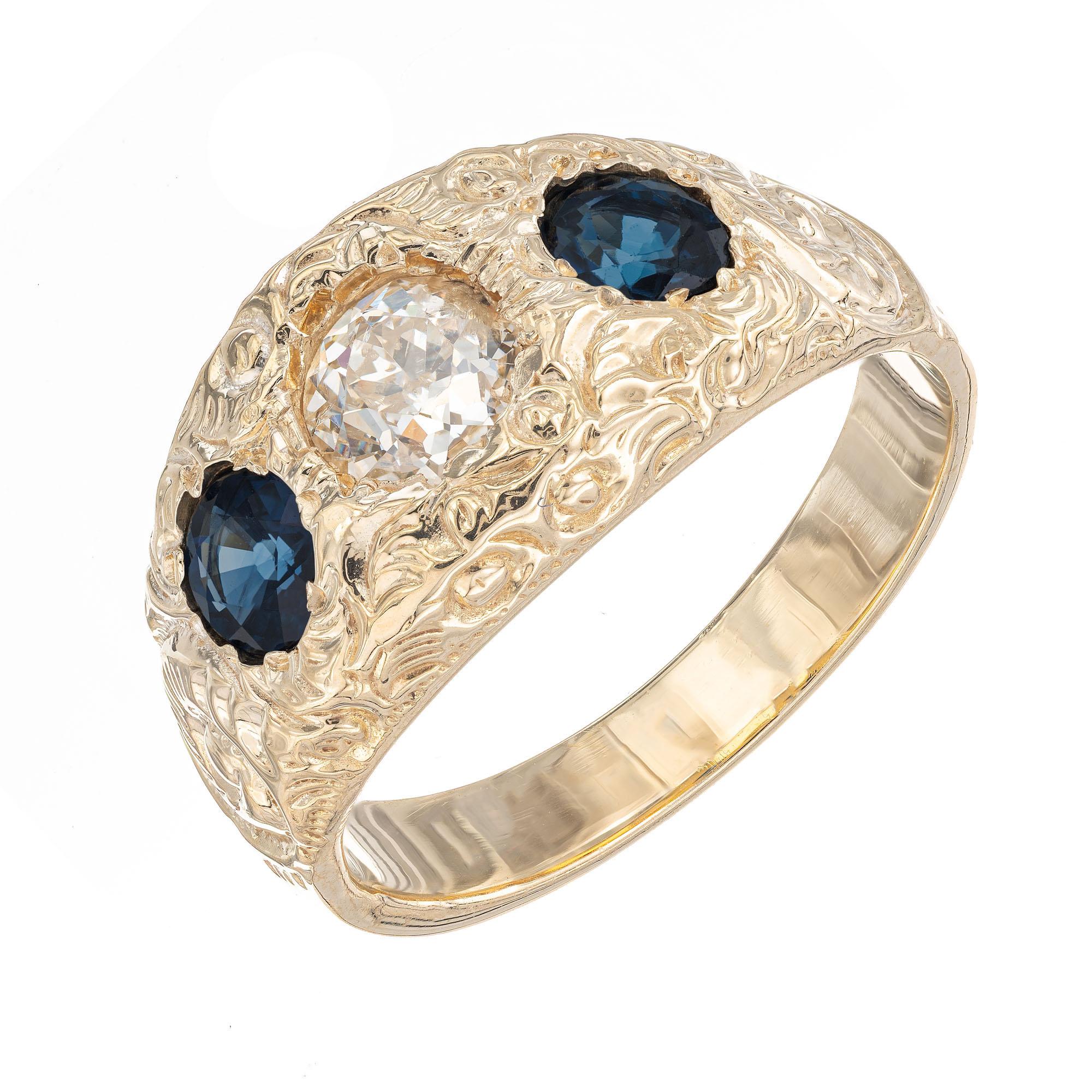 Diamond and sapphire ring. Old European cut center diamond with two round blue accent sapphires. Handmade and hand engraved 14k yellow gold.  Circa 1900

1 old European cut diamond, H-I I approx. .50cts EGL Certificate # 4001422244D
2 round blue