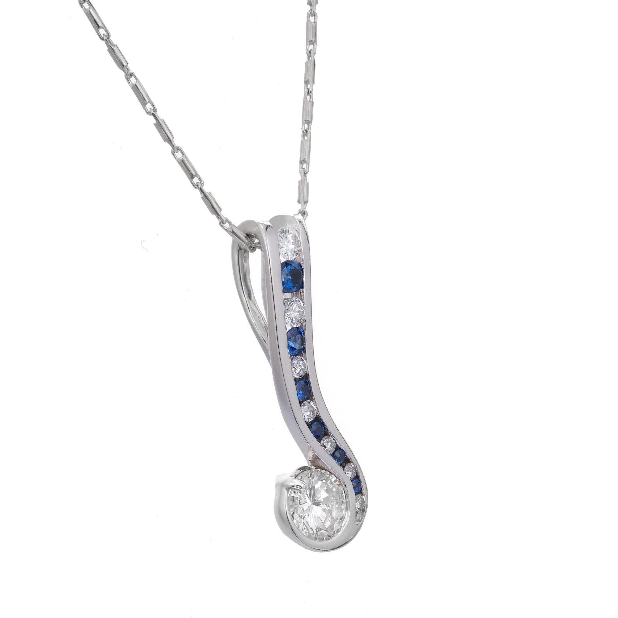 Diamond and sapphire pendant necklace. EGL certified round brilliant cut diamond with channel set round graduated diamonds and sapphires in a 14k white gold swirl pendant necklace. 18 inch chain. 

1 round brilliant cut diamond, approx. total weight