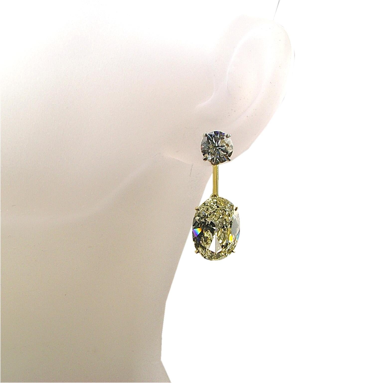 This 18K  beautiful dangling earring features 2 EGL certified Oval diamonds (5.00 & 5.02 Ct) Hanging off of a pair of Round Brilliant diamonds with total weight of 2.33 Ct. Look at the setting for the Oval diamonds that does not show any metal and