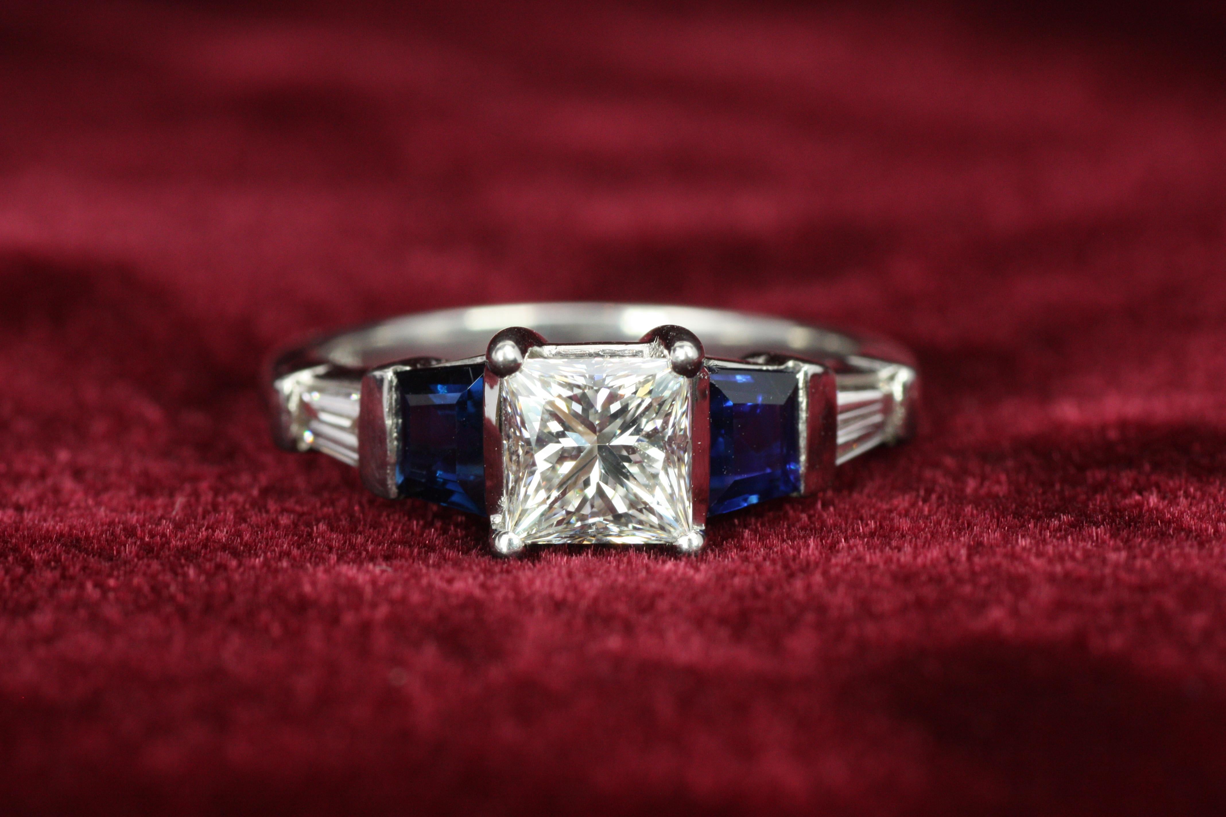 Celebrate timeless elegance with this stunning Art Deco engagement ring. Featuring a dazzling 1.05-carat princess-cut diamond (EGL certified, VS-1 clarity, E color) as the centerpiece, this ring is flanked by two baguette-cut diamonds and two