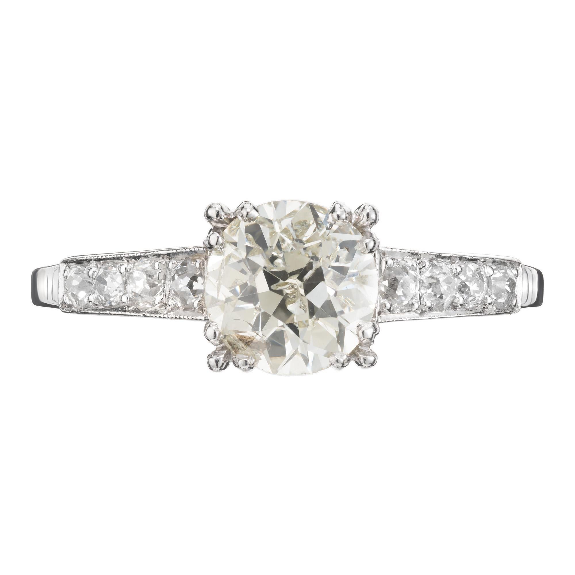 Early 1900's exquisite EGL Certified diamond platinum engagement ring. Old European cut 1.15ct is graded by the EGL as L, faint yellow hue with beautiful brilliance. Set in a lustrous platinum setting with four Old European diamonds on each
