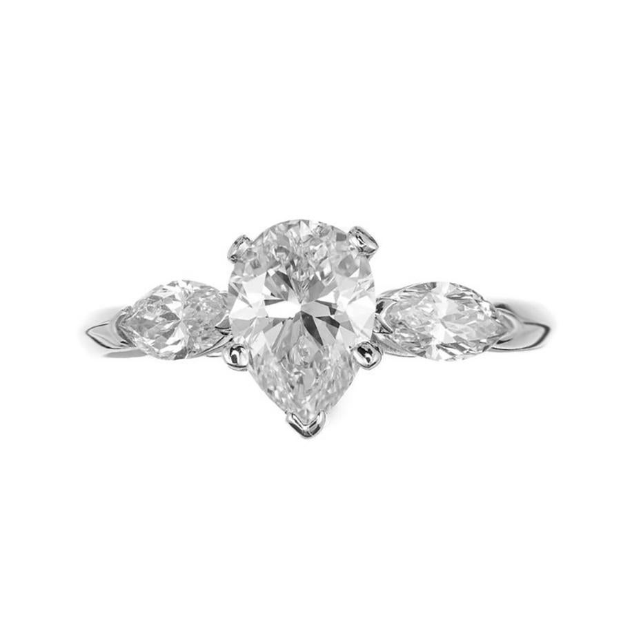 Experience timeless elegance with our EGL certified 1.25 Carat Pear and Diamond 14k white gold engagment ring. The center stone is a pear shaped, brilliant cut diamond that is accented by two Marquise shape side diamonds. The pear diamond is