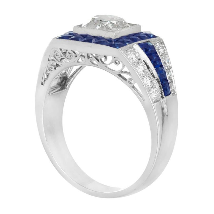 1920's Art Deco diamond and sapphire engagement ring. This stunning piece begins with an EGL certified 1.48ct antique cushion French cut center diamond with a halo of  French calibre cut Sapphires in a platinum setting. Both shoulders of the ring