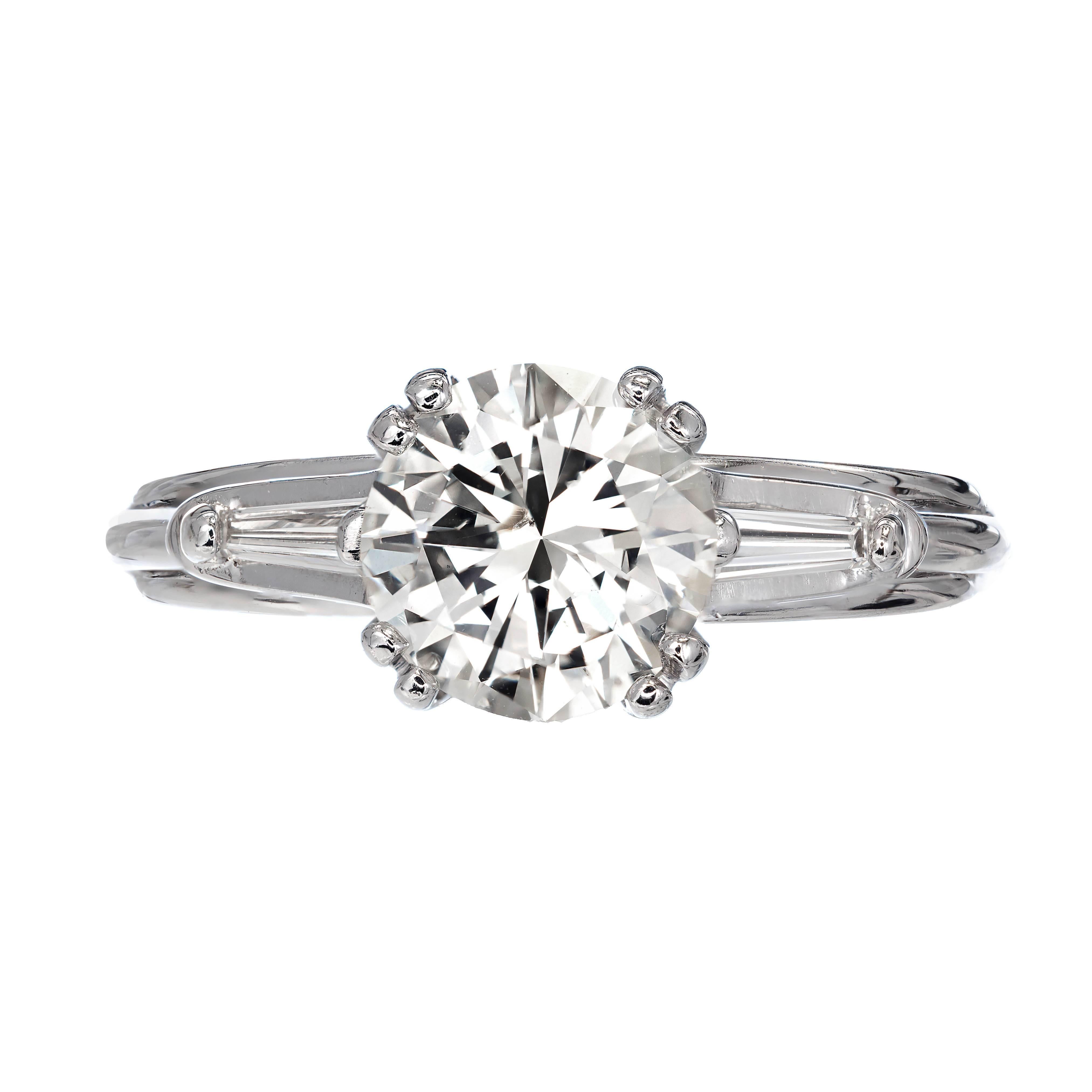 Three-stone round and baguette diamond engagement ring. This GIA certified round brilliant cut diamond faces up white and very bright. It is set in a handmade wire double prong 14k white gold setting. 

1.54ct Diamond M color, SI2 clarity, round