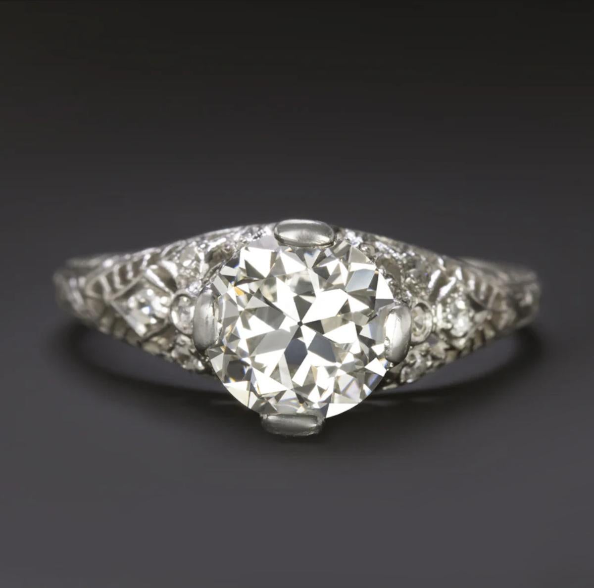 This original Art Deco engagement ring, handcrafted circa the 1930s, features a stunning 1.56 carat old transitional cut diamond at its center — EGL-USA certified and graded G-H color with VS2 clarity. Exceptionally clean and bright, the diamond