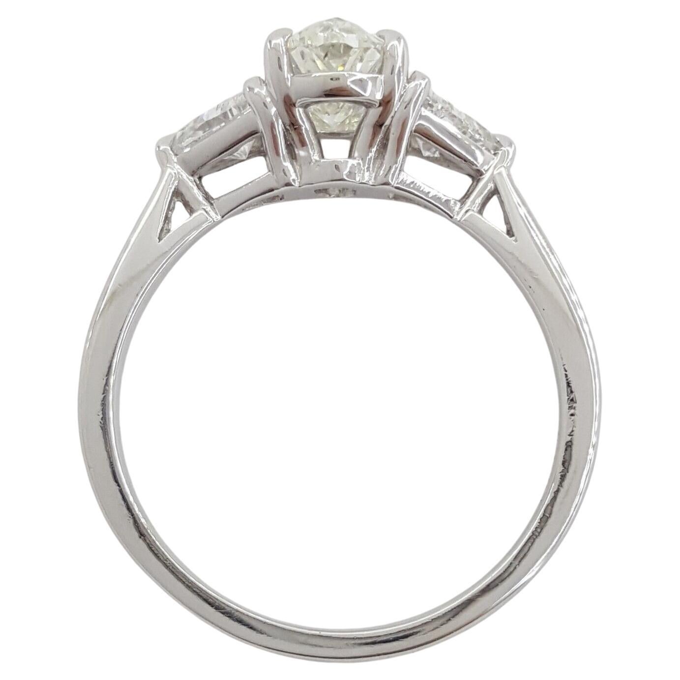 Platinum Three-Stone Oval Brilliant Cut Diamond Engagement Ring with a total weight of 1.91 carats. Weighing 5 grams and sized at 7.25, this elegant ring features a center stone of 1.31 carats, a Natural Oval Brilliant cut diamond with H color and