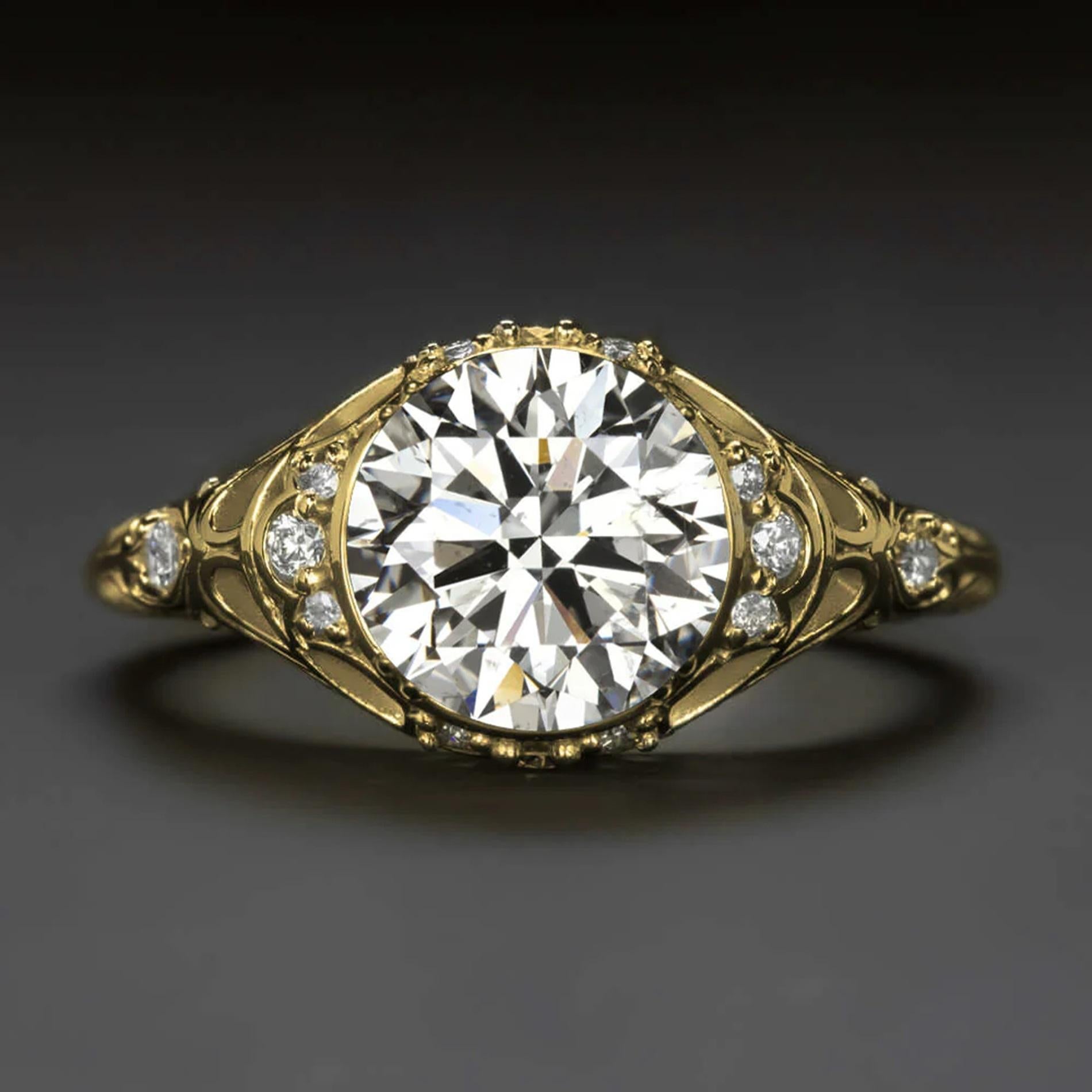 This vintage-style diamond ring commands attention with its impressive size and a beautifully detailed filigree setting adorned with diamonds. The generous 2-carat round brilliant cut center diamond captivates with its eye-catching size and dazzling