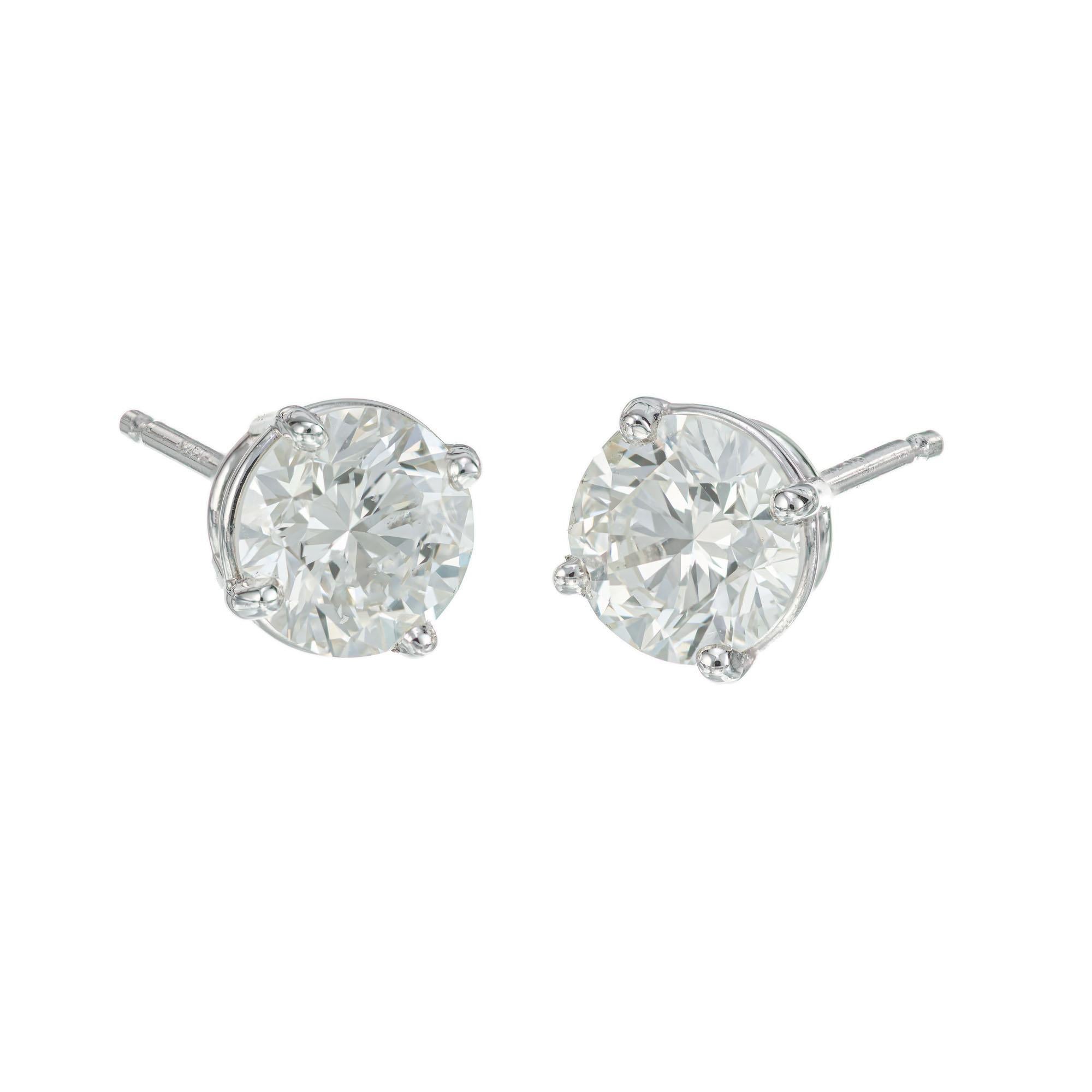 Diamond stud earrings. 2 round brilliant cut diamonds totalling 2.02cts, set in 4 prong platinum basket settings. 

1 round brilliant cut diamond, I-J VS approx. 1.08ct EGL Certificate # 400148925D
1 round brilliant cut diamond, I-J VS approx.