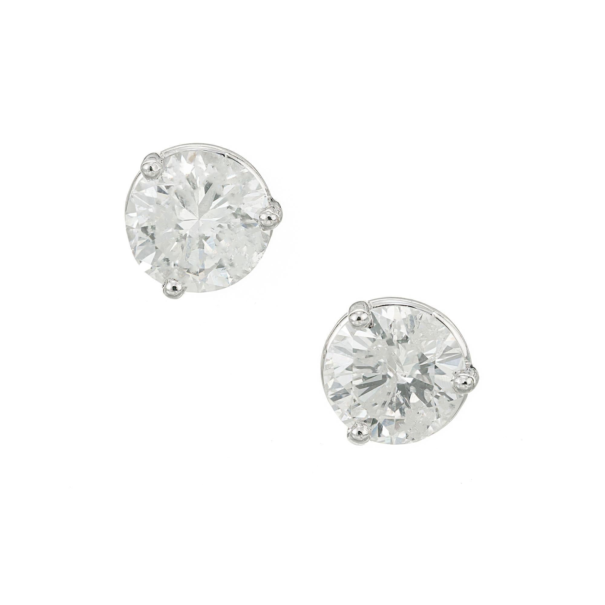 Bright white diamond stud earrings. 2.08ct round brilliant cut diamonds set in platinum basket settings.  

1 round brilliant cut diamond, approx. total weight 1.02cts, F - G, I1, 6.52 x 6.50 x 3.90mm, EGL certificate #US66679101J
1 round brilliant