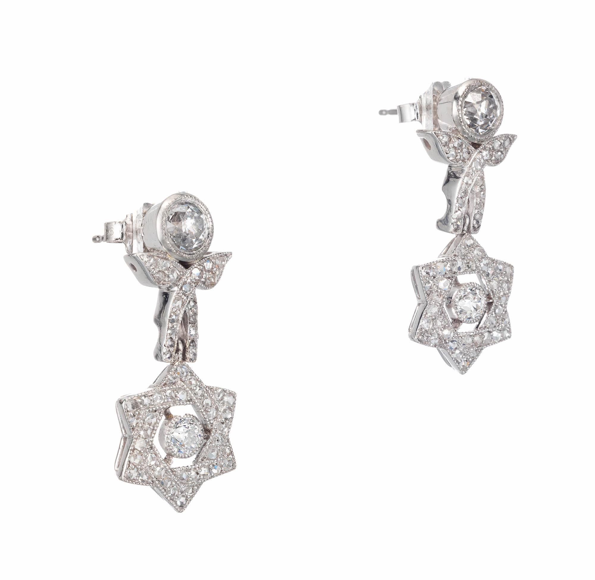Diamond star design dangle earrings. EGL certified Old European cut tops. Rose cut pave set star dangles in platinum. 

1 Old European cut G-H SI2 diamonds, Approximate .55 carats. EGL Certificate # 400115765D
1 Old European cut G-H SI diamond,