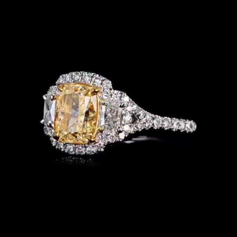 This EGL Certified handcrafted diamond ring features a captivating 2.18 Carat Natural Fancy Intense Yellow diamond, totaling 3.34 carats. The sparkly diamond is mounted on an 14K yellow gold 4-prong setting with an 14K white gold pave set Split