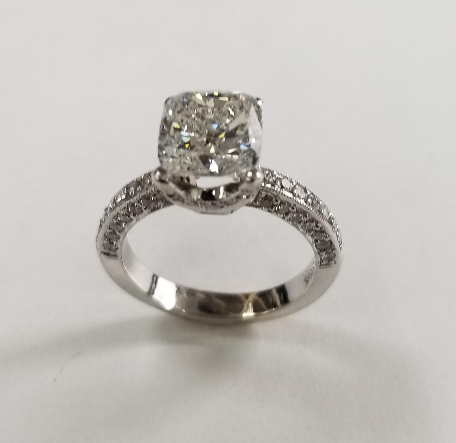 EGL Certified 3.06 carat Cushion cut Diamond E Si3 (US 918748207D) set in a 14k wg pave' setting, containing  60 round full cut diamonds of very fine quality weighing .66pts. ring is a size 6.25 and can be sized to fit for free. 