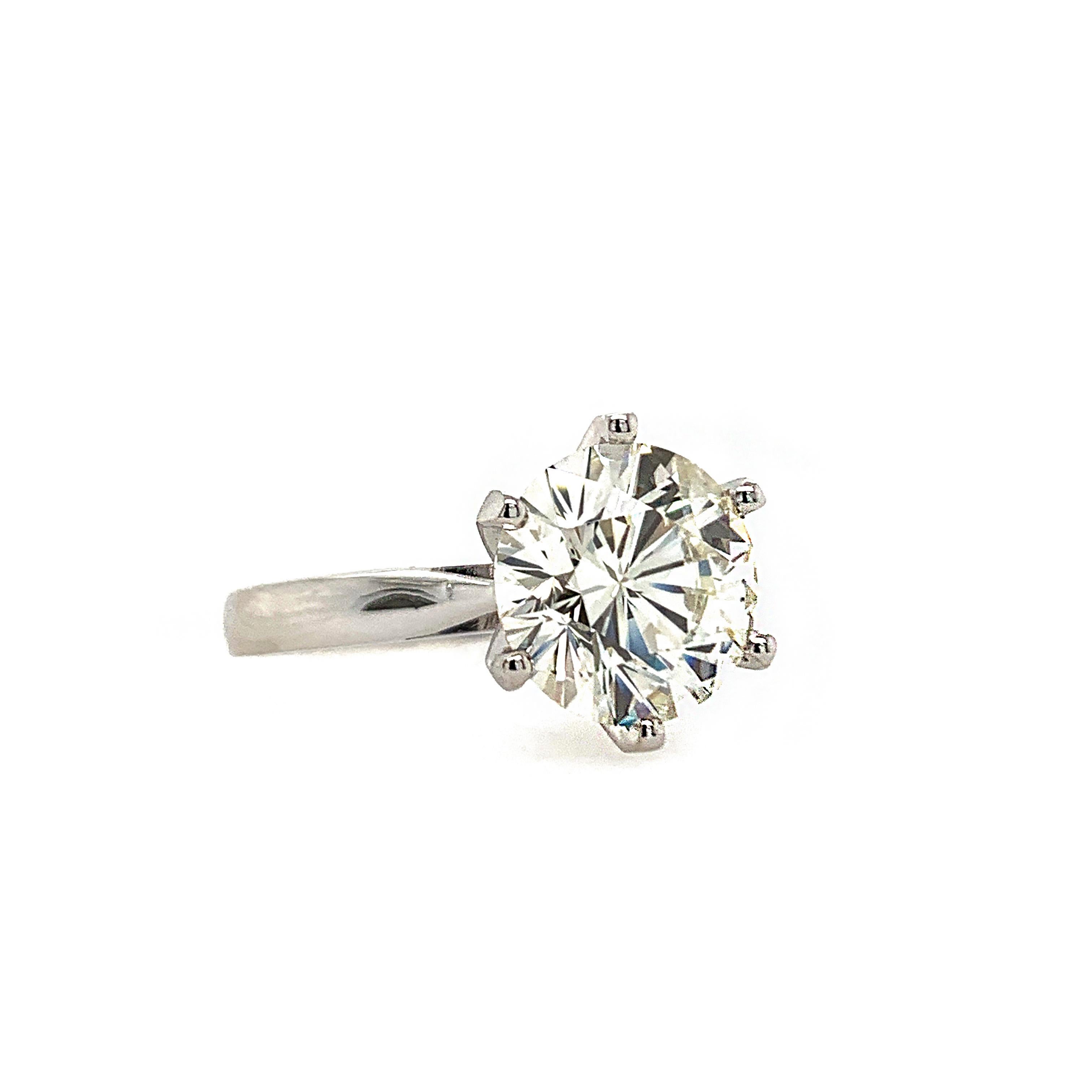 This breathtaking solitaire ring flaunts a 3.53 carats round brilliant natural white diamond set in a 6 prong setting.

Set in 14K white gold.

Center stone: Natural white diamond - 3.53 carats, color H, clarity SI1 (comes with EGL