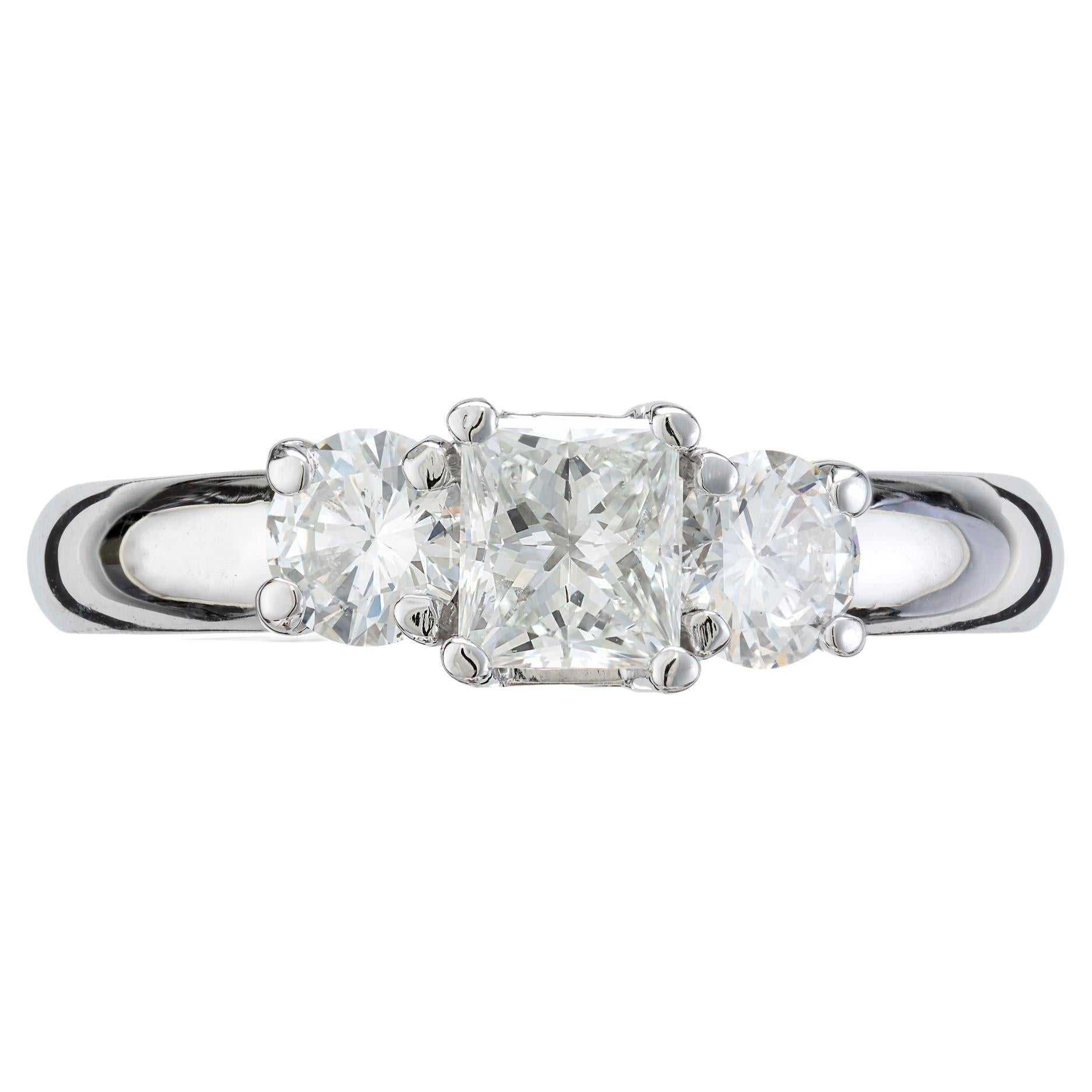Classic neat clean low set three stone diamond engagement ring. EGL certified .48ct princess cut diamond center stone set in a simple three-stone platinum setting with two round side diamonds. This princess cut diamond is certified by the EGL as