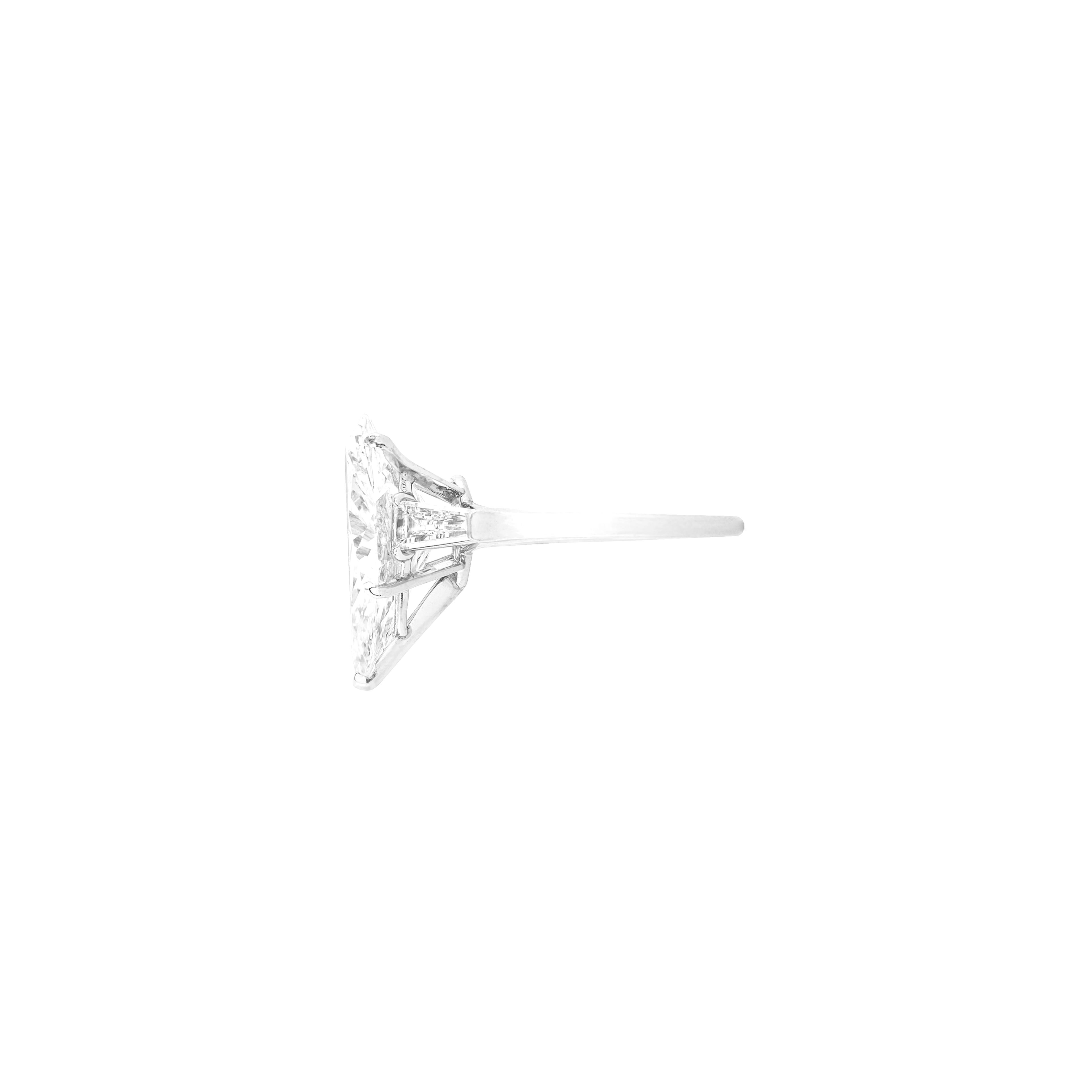  EGL-USA certified pear-cut diamond weighing 5.11 carats. The diamond is graded F for color and SI2 for clarity, indicating that it is bright white and eye clean. The ring is enhanced by tapered baguette side stones, adding an elegant touch to the