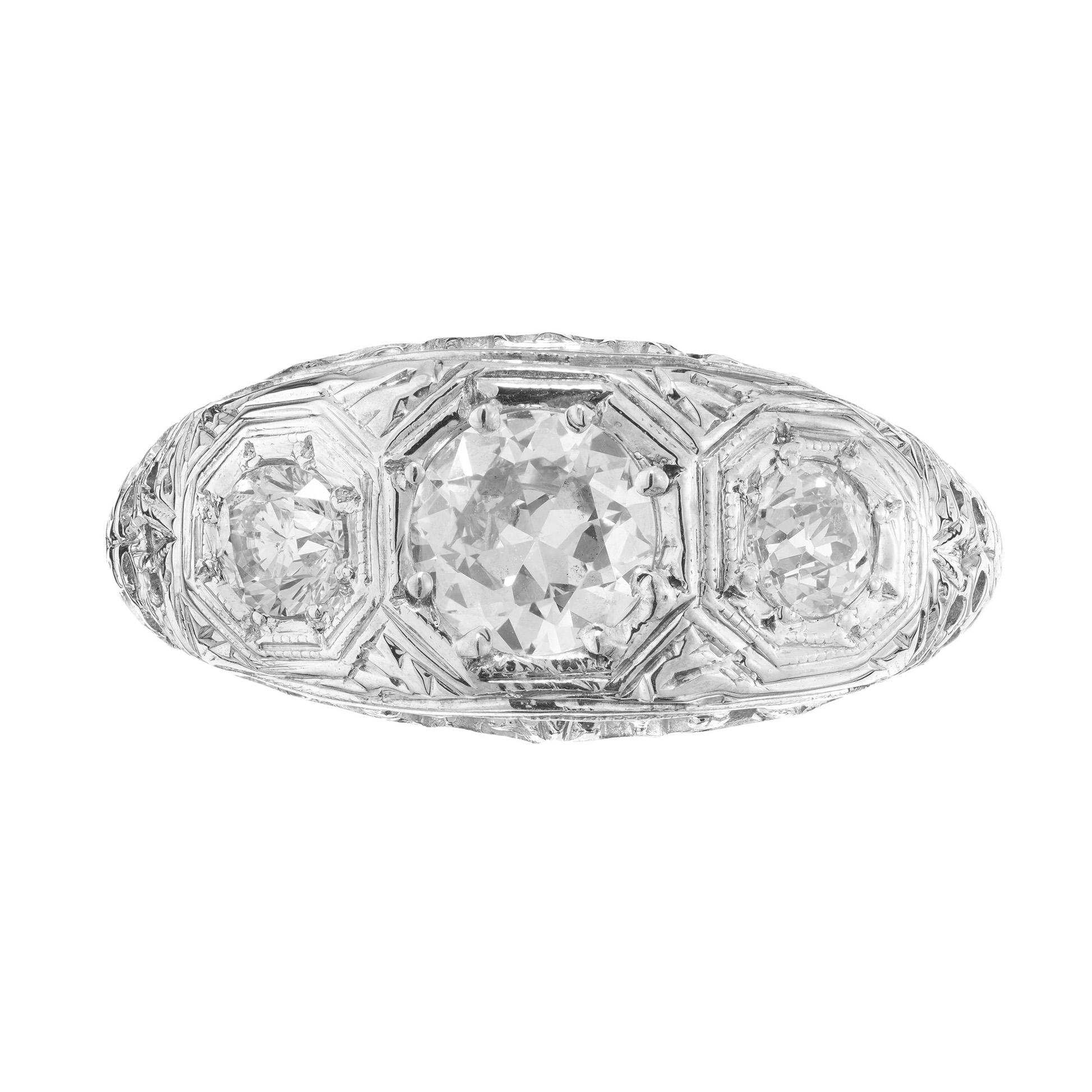 Wonderful 1930's Art Deco diamond domed engagement ring. This three-stone ring begins with a .52ct old European brilliant cut diamond center stone. Accented by 2 old European cut side diamonds. All three are set in a filigree engagement setting made