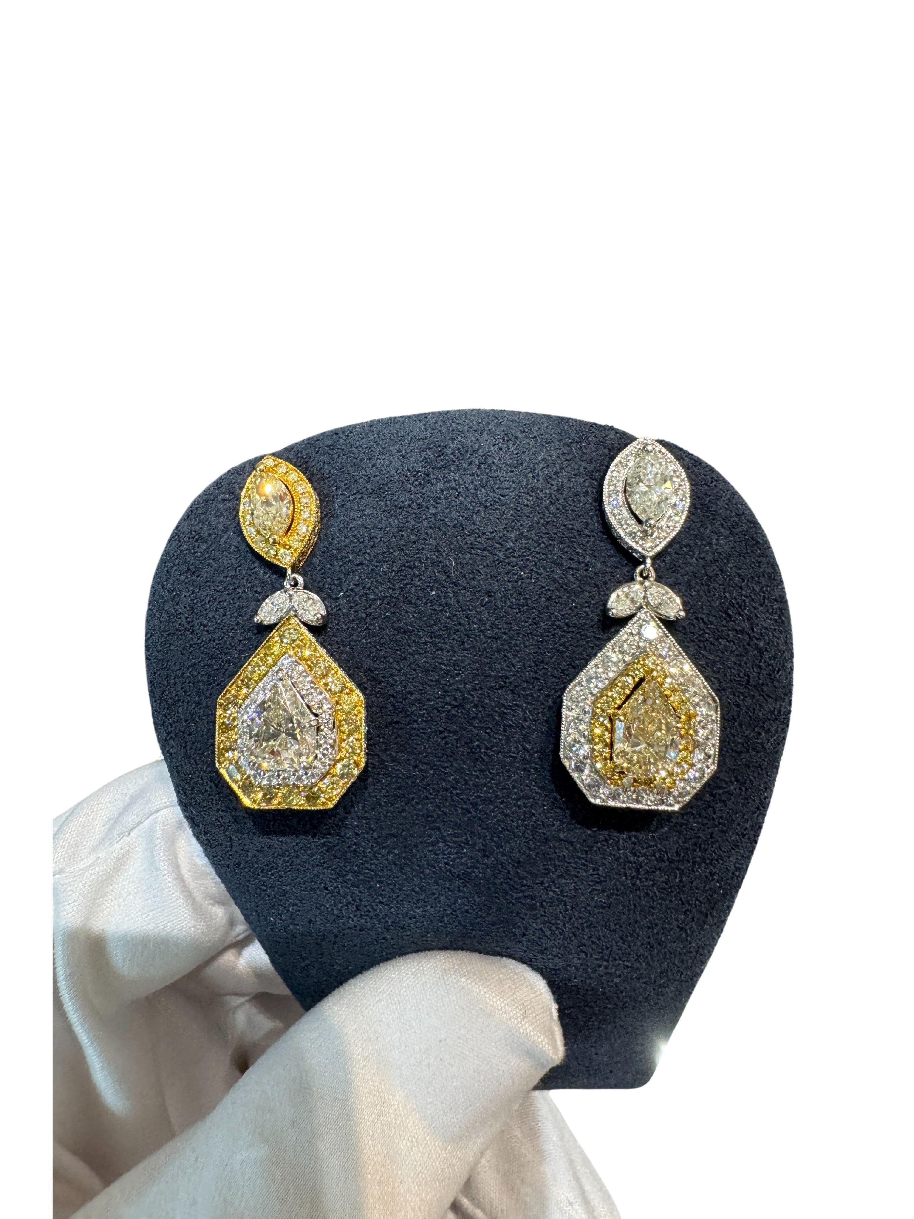 EGL Certified Multi Cut White and Yellow Diamond Inverse Dangle-Drop Earrings. 

Multi cut dangle drop inverse earrings. Marquise, round, and fancy-cut white and yellow diamonds total 5.68 carats between both earrings. Featuring a two-tone 18k white