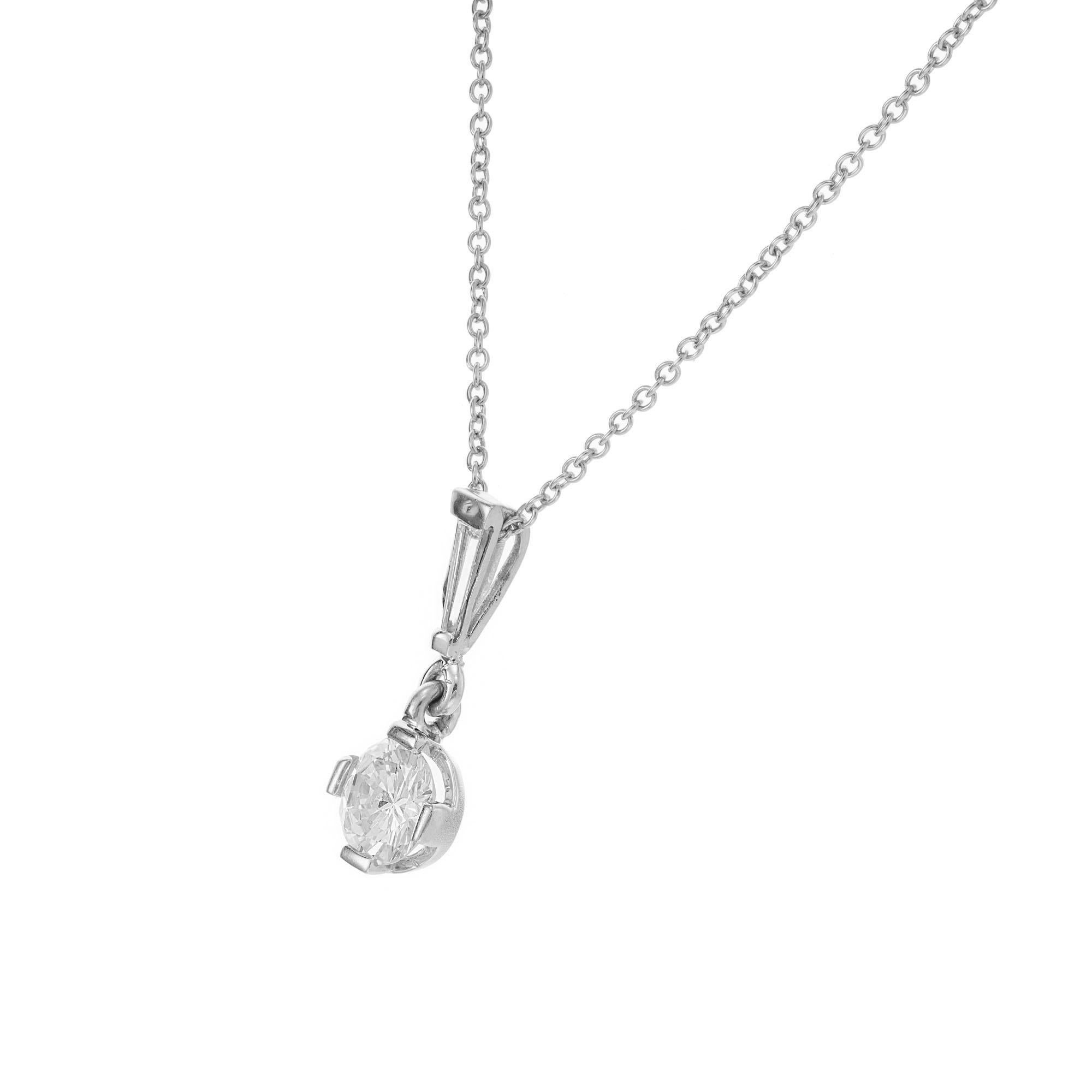 1940's late Art Deco diamond pendant necklace. EGL certified center stone with a tapered baguette accent diamond set in platinum. 16 inch chain.  

1 round brilliant cut diamond, L-M VS approx. .68cts EGL Certificate # 400145984D
1 baguette diamond,