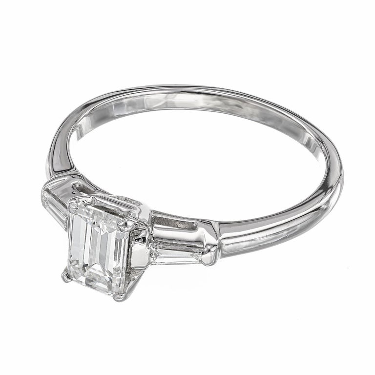 Diamond three-stone engagement ring. EGL certified Emerald cut center diamond in a platinum setting with 2 tapered baguette side diamonds. 

1 emerald cut diamond, H-I SI2 approx. .73cts EGL Certificate # 1122997877
2 tapered baguette diamonds, H-I