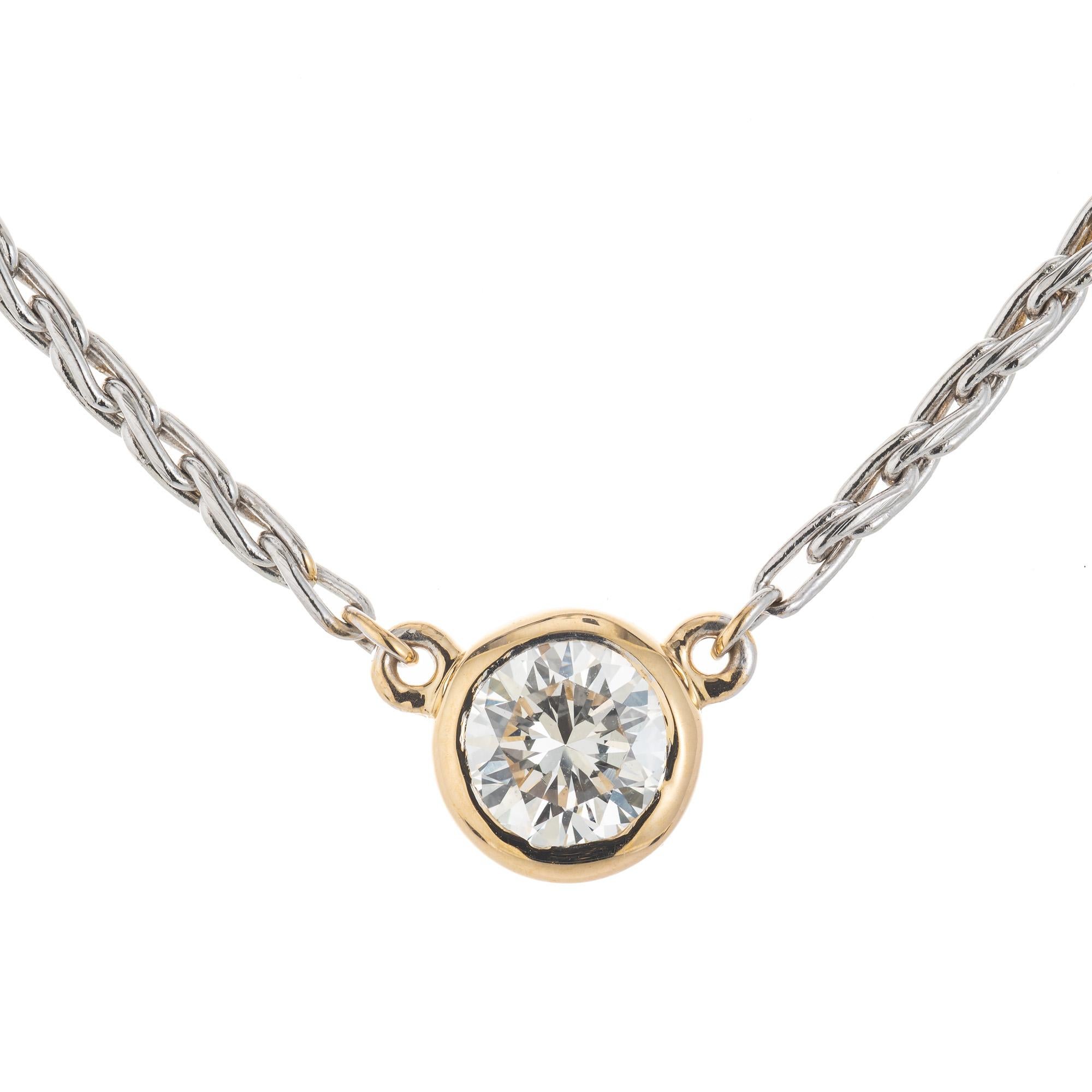 Beautiful and simple, EGL Certified .74 carat round brilliant cut diamond solitaire pendant necklace with a yellow gold bezel and white gold chain. EGL has certified this as I-J, near colorless. Completed with a 16 inch 14k white gold chain.  

1