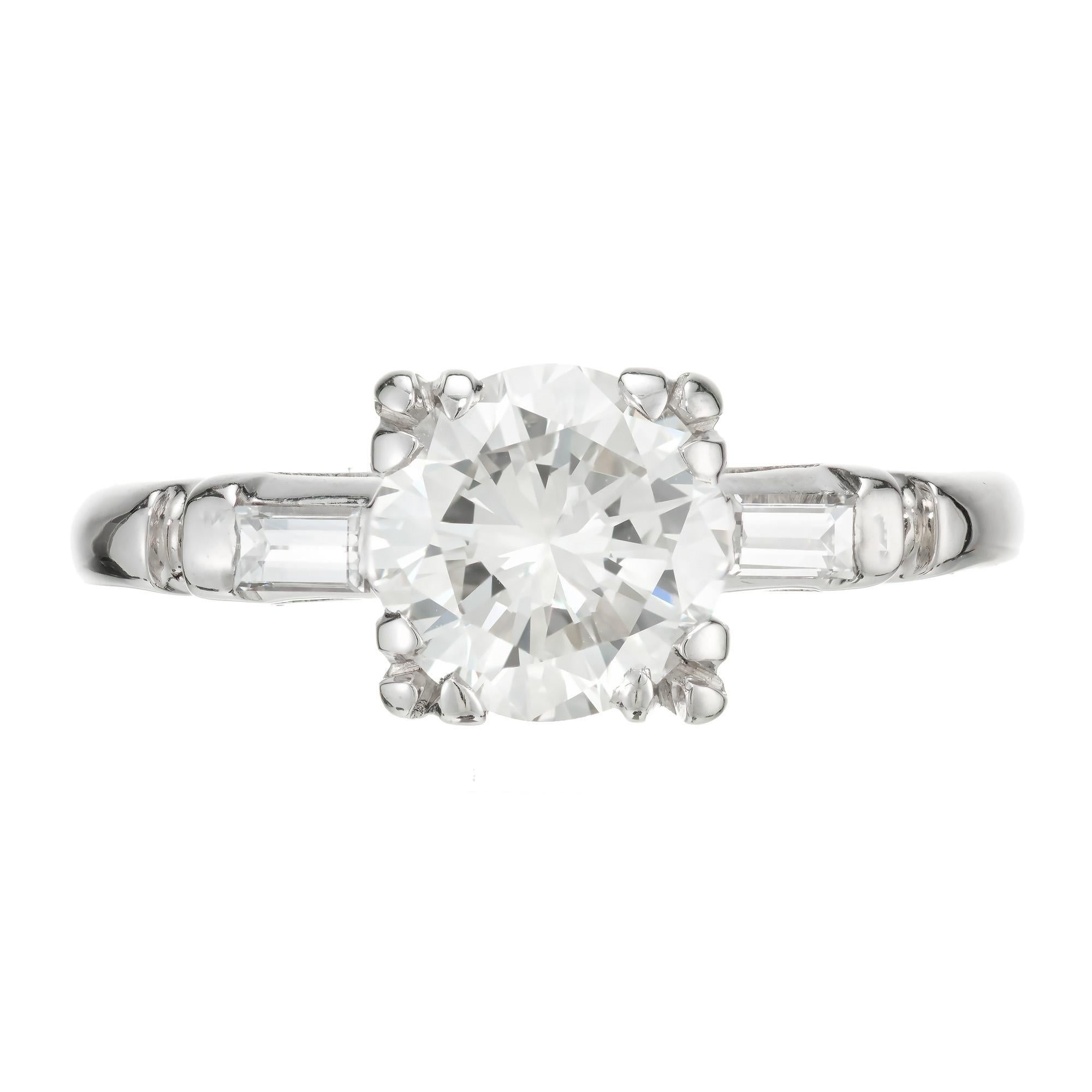 1940's vintage diamond engagement ring. EGL certified round brilliant cut center diamond. In a palladium three-stone setting with 2 straight baguette diamonds. The diamond was not removed for grading. During World War II, platinum went into the war