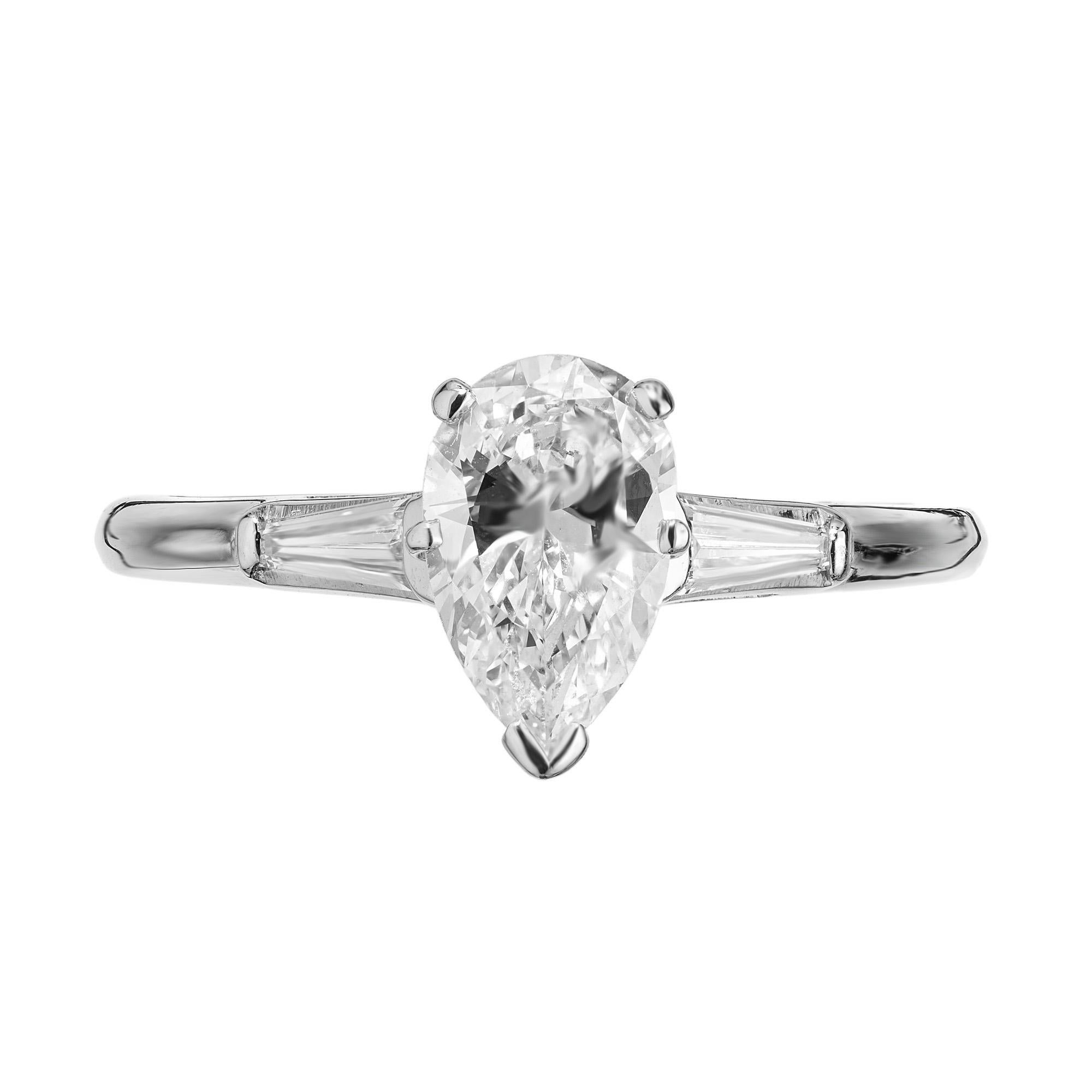 Beautiful vintage 1960's certified .95 carat pear shaped diamond in its original seven prong platinum setting flanked by tapered diamond baguettes. This exquisite ring is in excellent condition and catches light from every angle, creating a dazzling