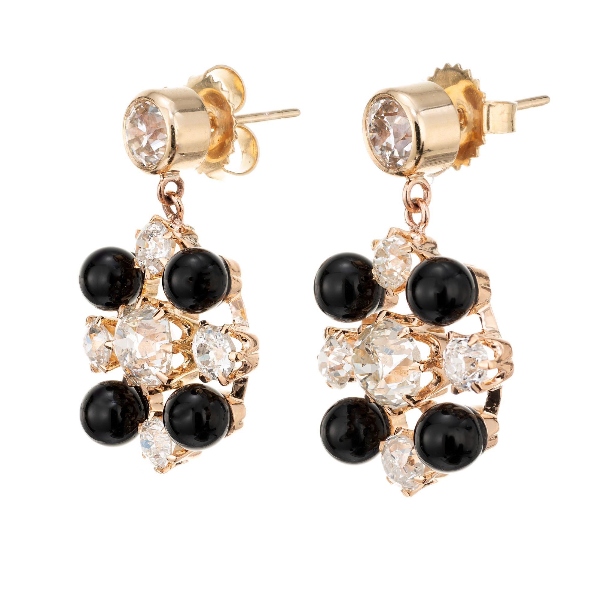 1890's Victorian Diamond and onyx dangle earrings. 14k rose gold settings with 8 round black onyx and 12 Old European brilliant cut diamonds. The two largest (center) diamonds are EGL certified.  Top diamonds are bezel set in 14k yellow gold. Dangle