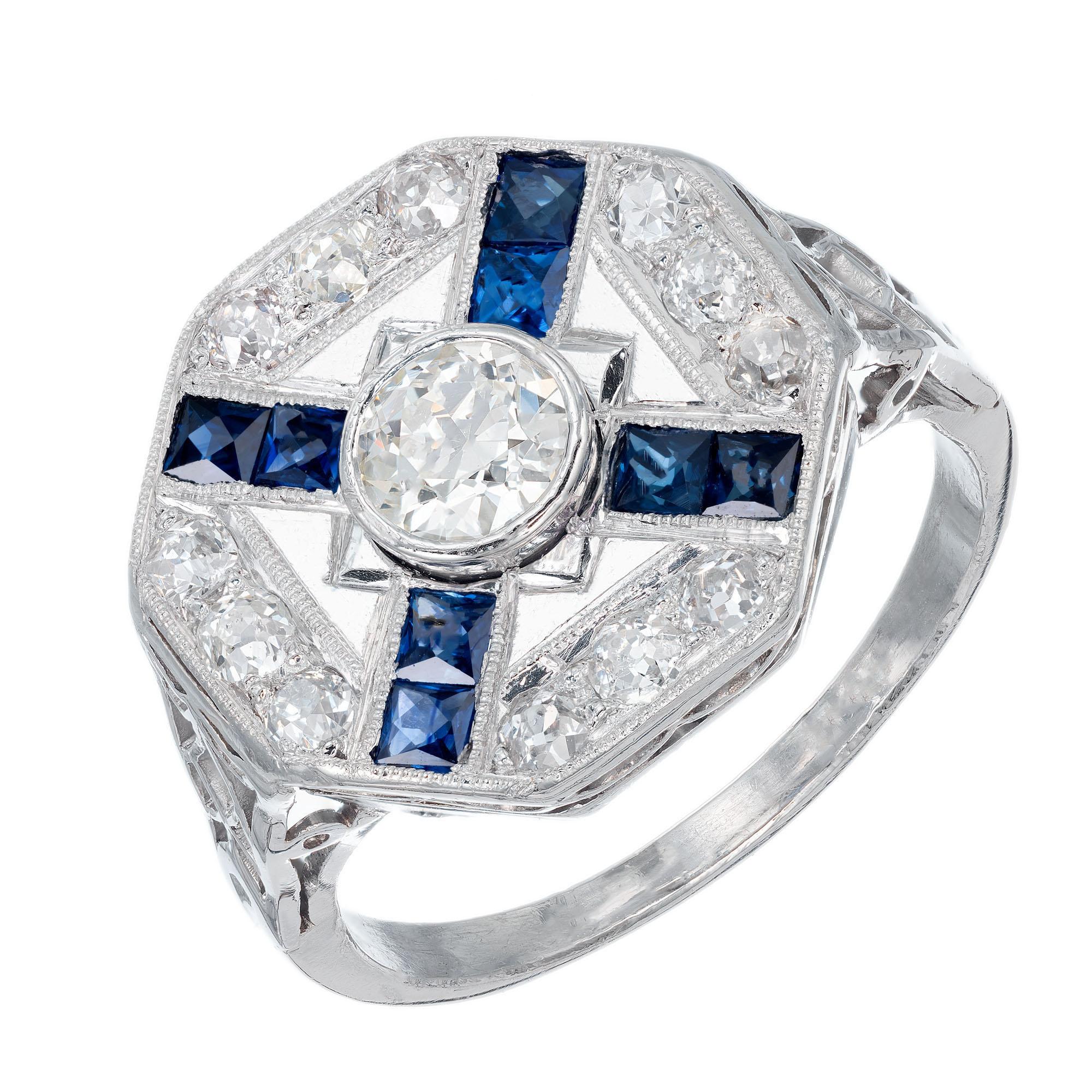 Old European center stone with square French Claibre shaped sapphires and round accent diamonds in an octagonal 