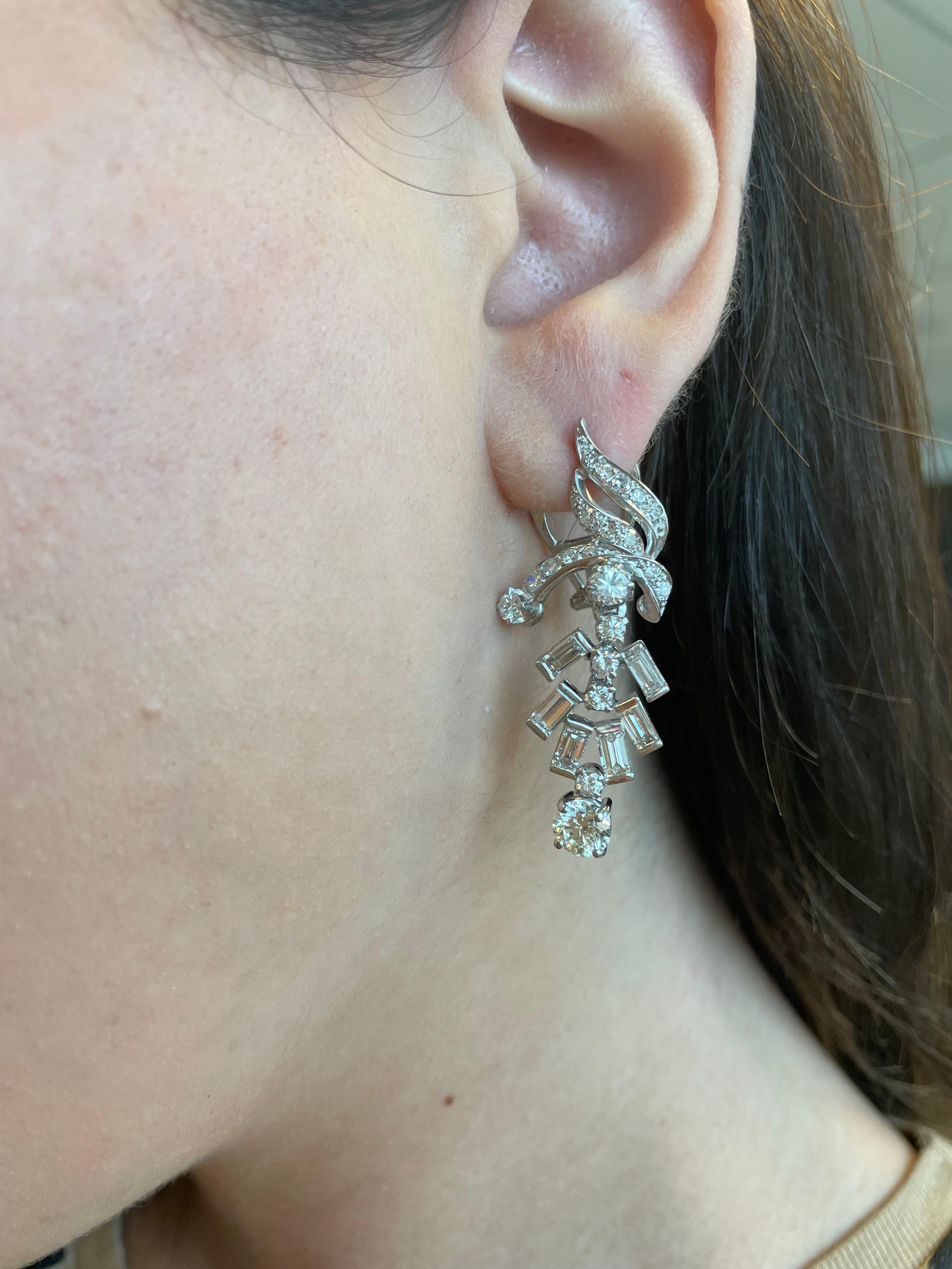 Stunning Edwardian inspired chandelier earrings.
2 center round brilliant diamonds, 1.40ct EGL certified. One stone H color grade and the other I color grade, both VVS2 clarity grade. Complimented by 4.00ct of round brilliant and baguette cut