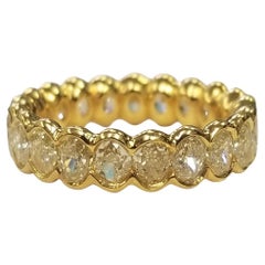EGL Certified Light Fancy Yellow Oval Cut Bezel Set Eternity Diamond Ring