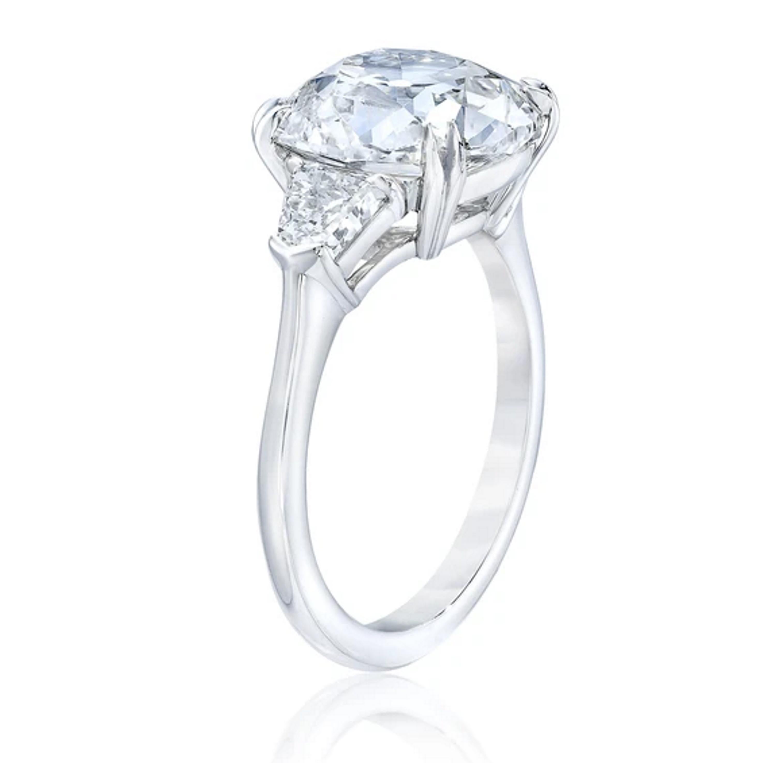 This three stone diamond ring features an 1.17 Old Mine Cut center 
GIA Certificate Included
Gemstone:  Diamond
Diamond Weight: 1.17 Carats - Old Mine Brilliant Cut - 
Center Diamond Color: E
Diamond Clarity: SI 2

