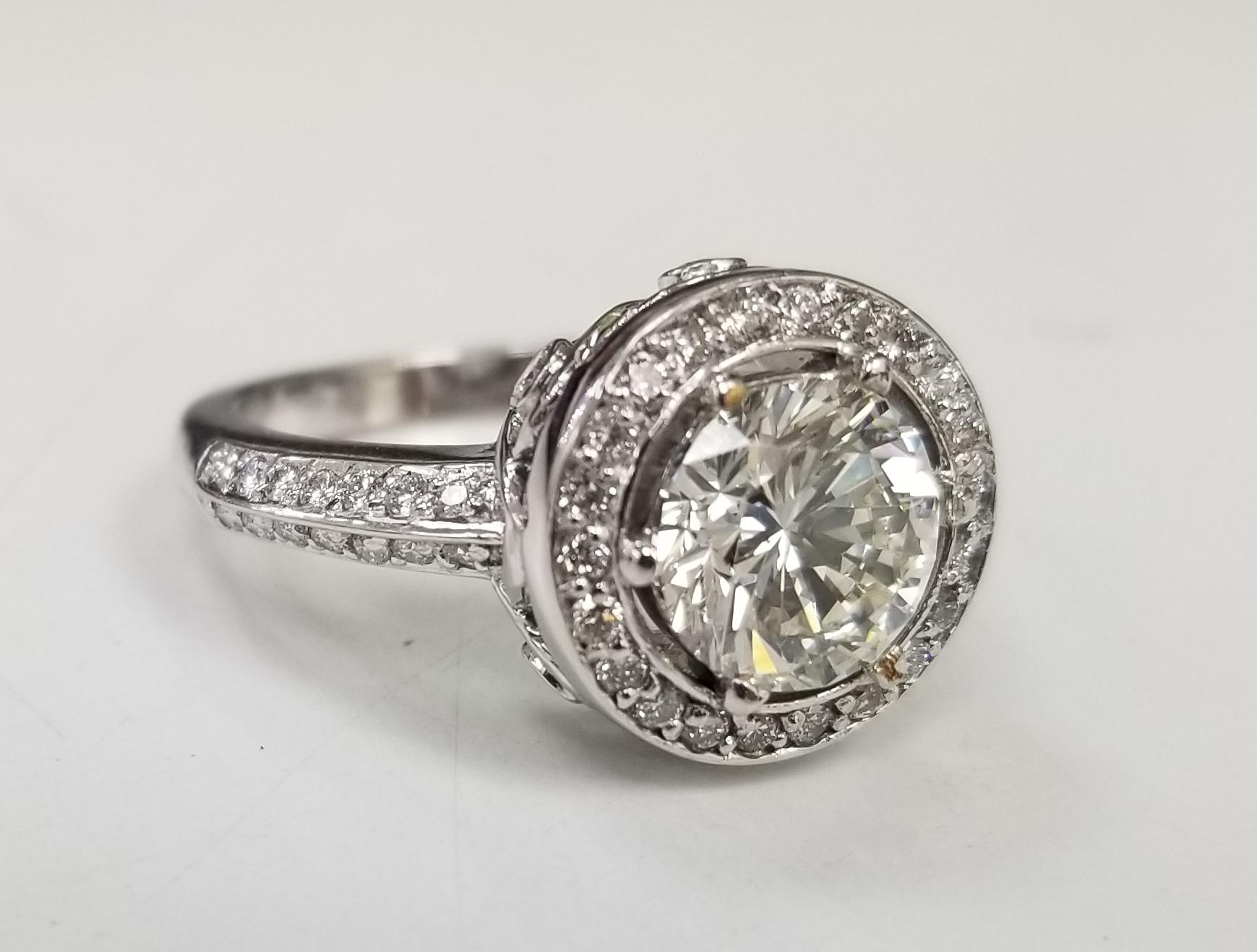 EGL Certified Round 2.01 H color and clarity SI1 14k white gold round diamond halo ring, containing 54 round full cut diamonds weighing .65pts., color 