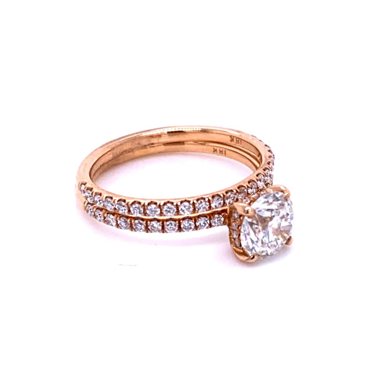 A very shiny Round Brilliant G/SI2 EGL US certified center Diamond set in a fine 18k gold Pave Set Engagement Ring along with a Pave Set Matching Band. Total diamond weight of 0.23 Ct. on the side Engagement Ring and 0.19 Ct on the Matching Band .