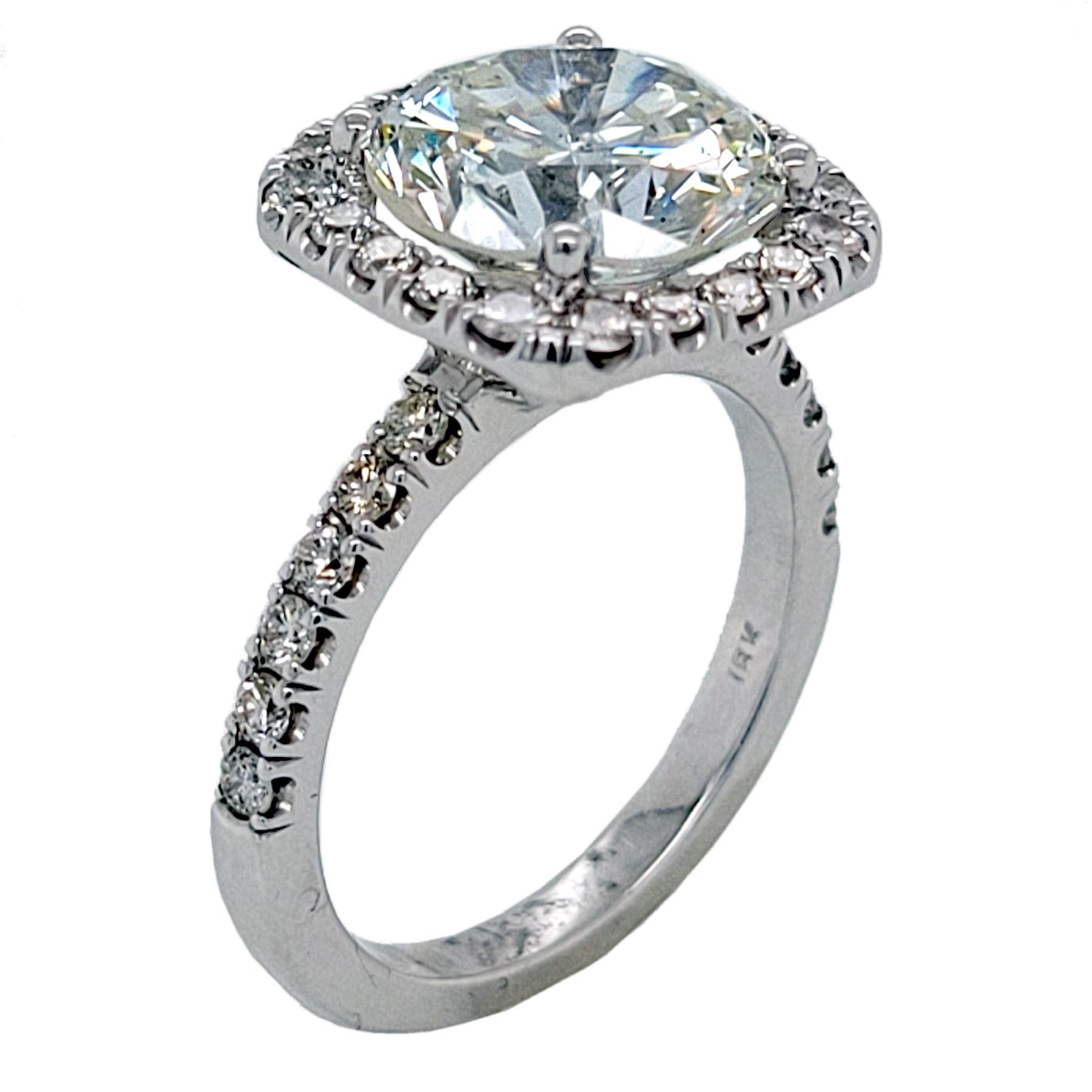A very shiny 3.87 Ct Round Brilliant I/SI1 EGL US certified center Diamond set in a fine 18k gold Pave set Engagement Ring with a halo. Total diamond weight of 0.84 Ct. on the side. 

Diamond specs:
Center stone: 3.87 Ct EGL US Certified I/SI1 Round