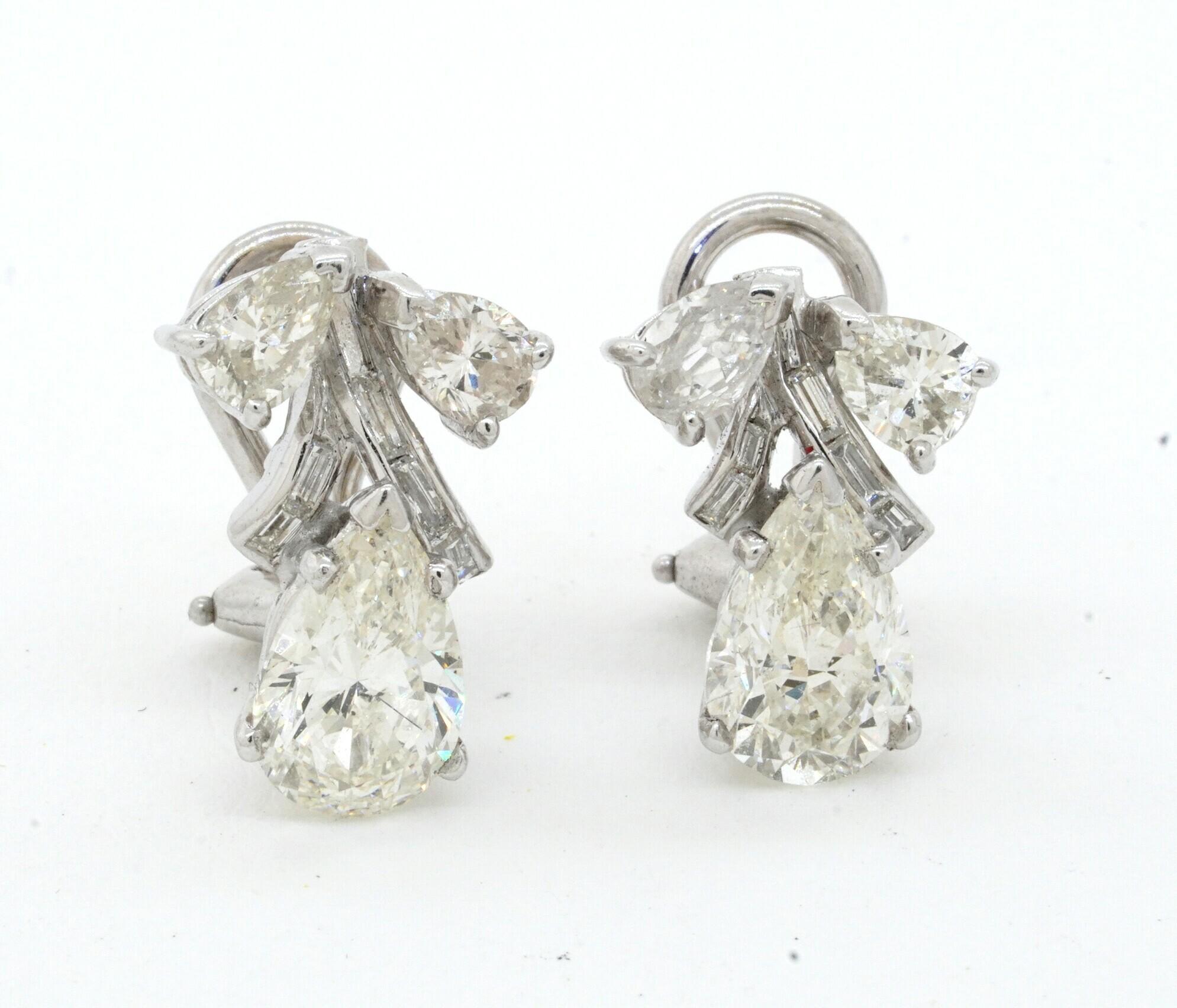 EGL USA 1950s Platinum 4.54CT VS-SI Pear diamond earrings w/ approx. 1.5CT ctrs. This extraordinary set of earrings are crafted in gorgeous Platinum and feature 16 diamonds, with a combined weight of approx. 4.54CT. This includes EGL USA certified