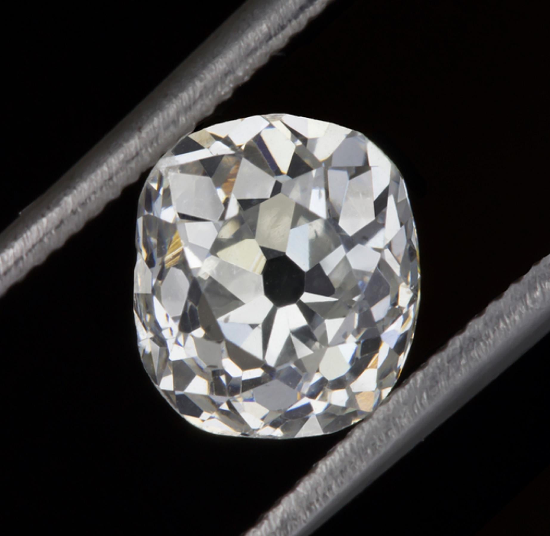 This striking and bright white 1 CARAT old mine cushion cut diamond has charmingly wide hand cut facets that sparkle dazzlingly and have spectacularly vivid fire! Graded G for color, it is brilliantly white, a rare feature in old cut diamonds! Cut