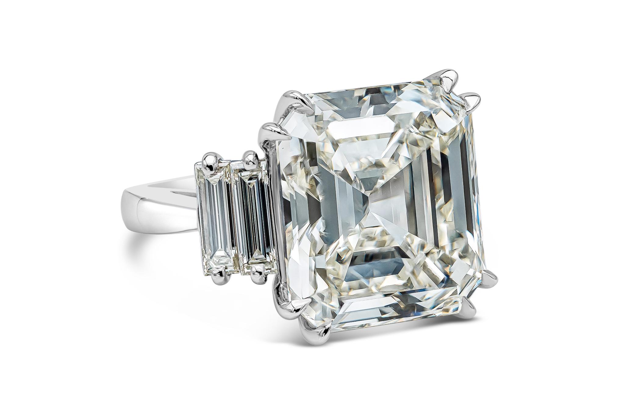 Elegant and well crafted engagement ring showcasing a square emerald cut weighing 18.75 carats, flanked by four elongated baguette cut diamonds weighing 1.43 carats total. Set in a polished platinum mounting. EGL USA certified the cushion cut as J