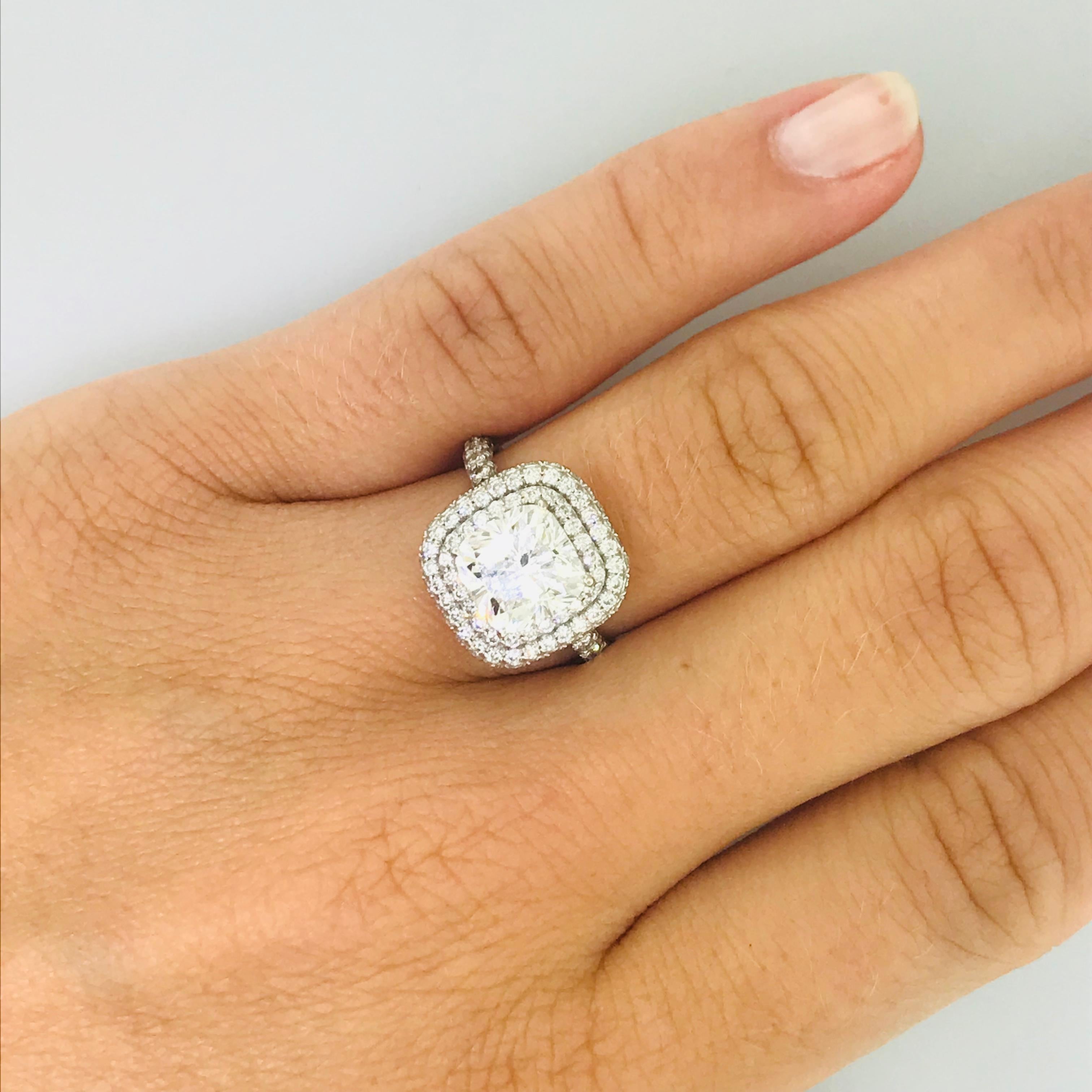 Bold & Beautiful Cushion Diamond Engagement Ring and Gorgeous on any hand! The cushion diamond double halo engagement ring holds a 2.51-carat cushion diamond that is accompanied by a laboratory certificate. The center diamond is a bright white H