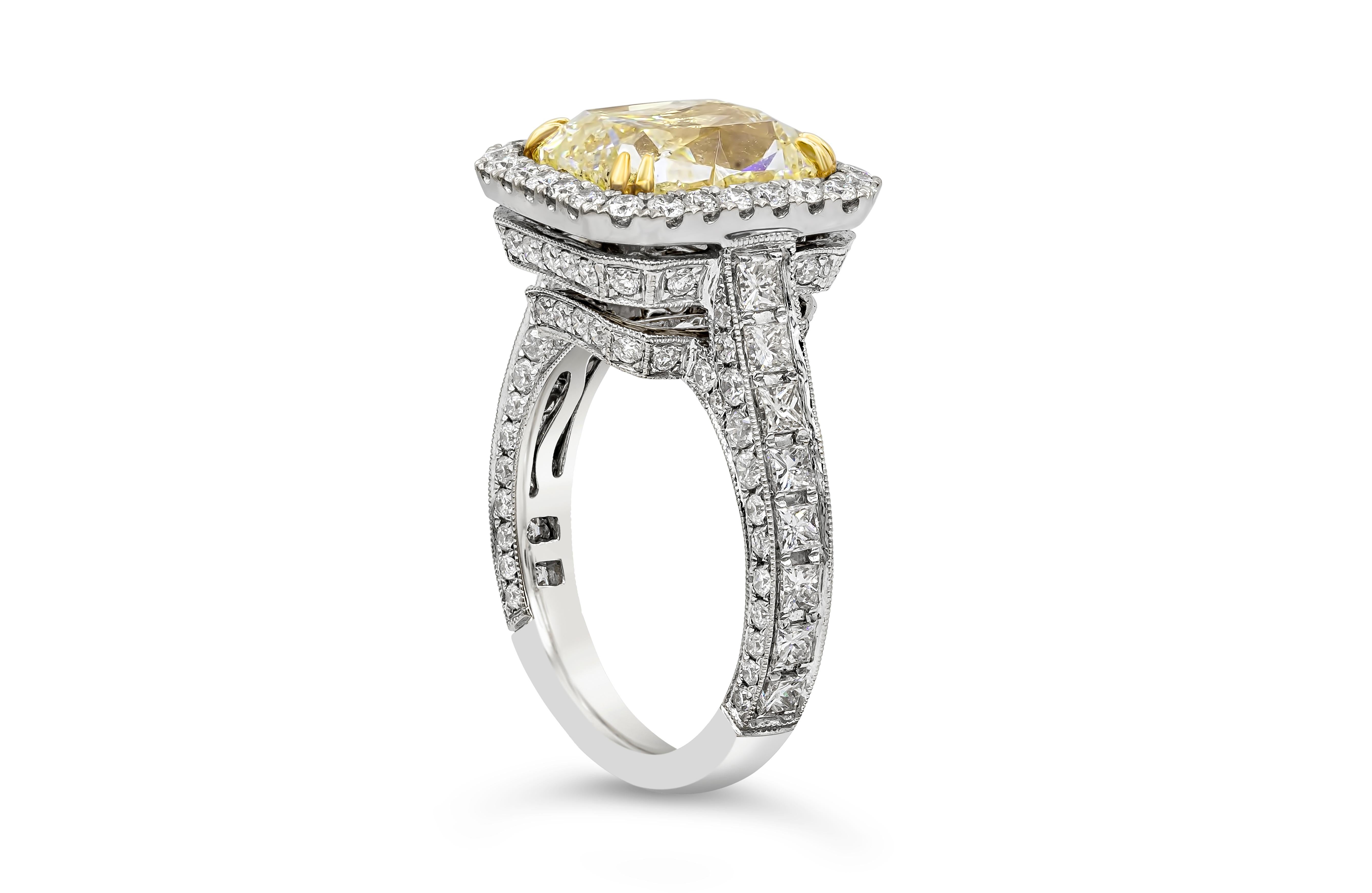 A contemporary engagement ring showcasing a 5.07 carats elongated cushion cut diamond, certified by GIA as Fancy Light Yellow color, SI2 in clarity, set in a timeless yellow gold eight prong setting. The center diamond is surrounded by a single row