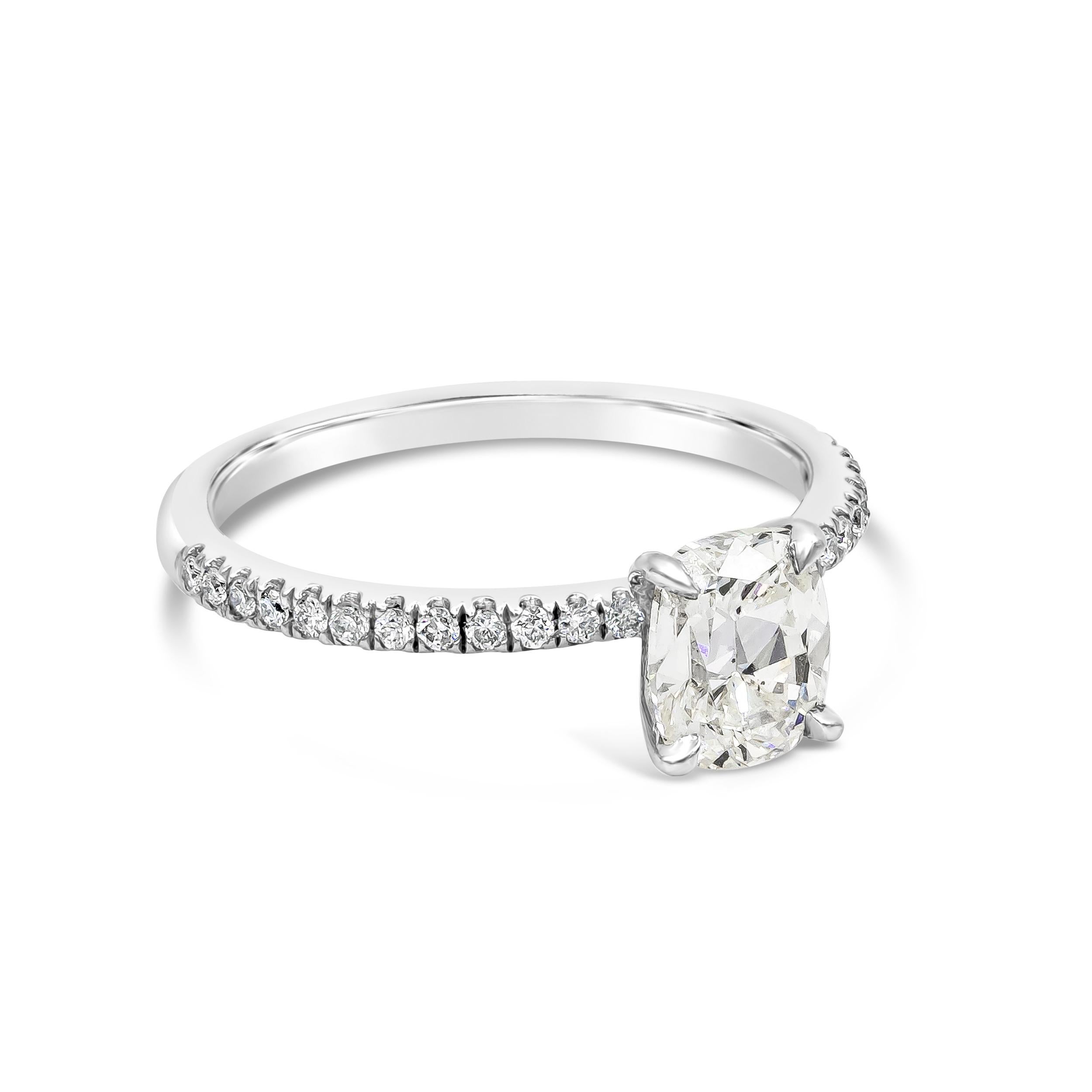 A classic engagement ring style showcasing a 1.10 carats cushion cut diamond certified by EGL as J color, SI1 in clarity, set in a timeless four prong basket setting. Center diamond set in a platinum band accented with round diamonds weighing 0.16
