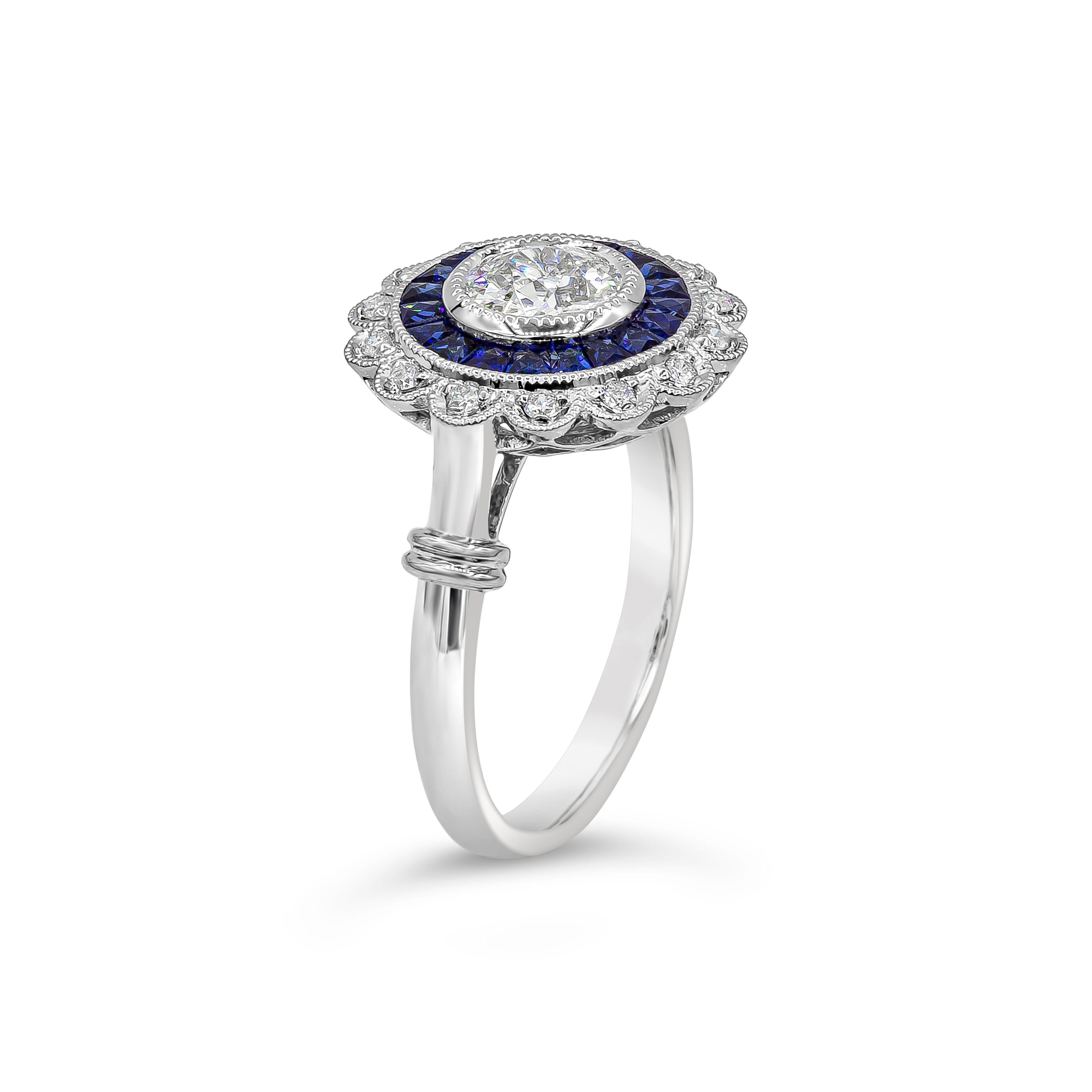 An antique style ring showcasing a 0.75 carat old european cut diamond, elegantly set in a halo made with french cut blue sapphires weighing 0.70 carats total. Finished with round brilliant diamonds arranged in a floral motif. Made in platinum.