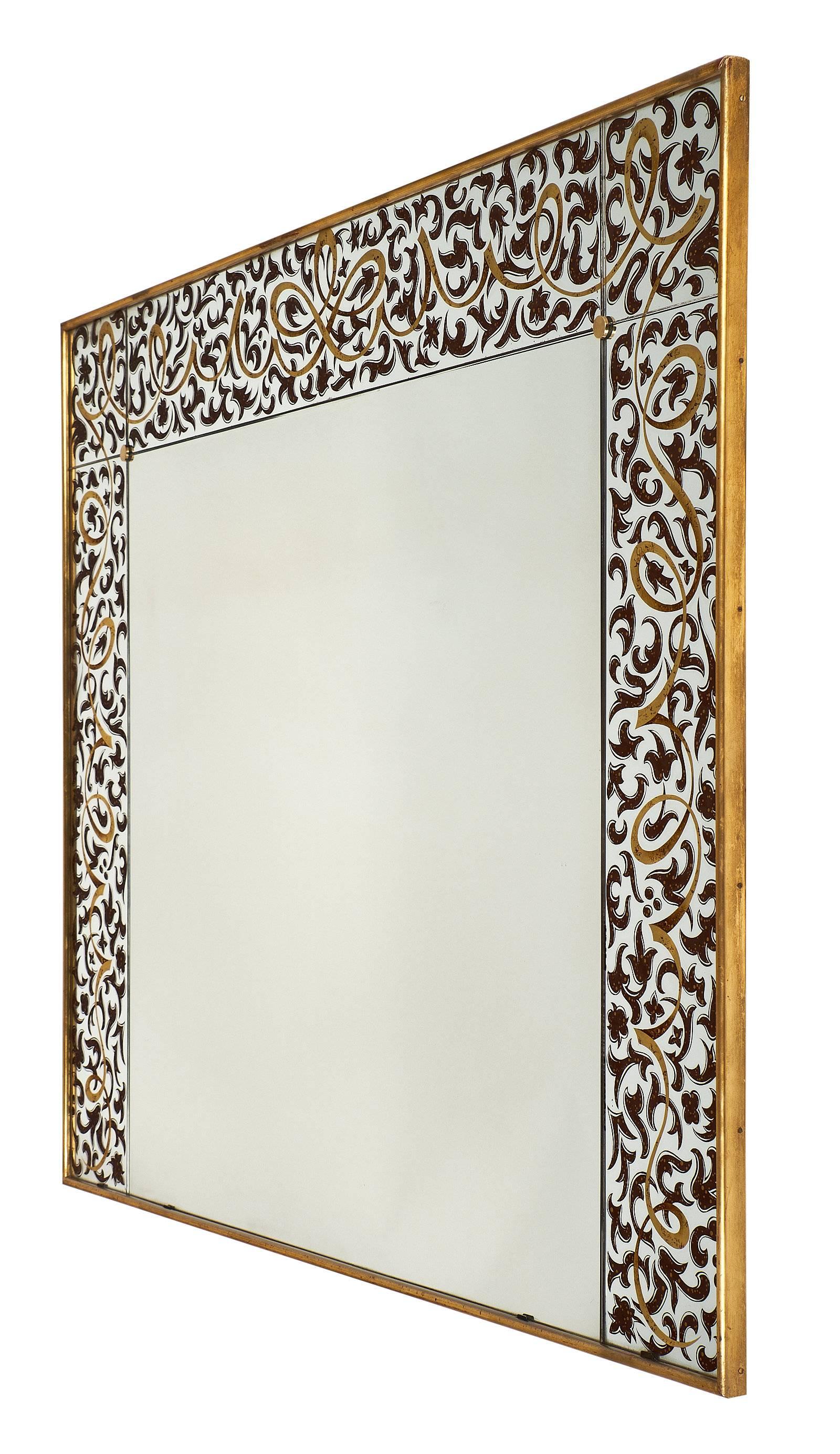 An important French Art Deco period “Grand Salon” mirror with an outer frame formed by finely églomiséd work in gold and bronze colors representing ribbons, arabesques, and scrolls in a very dynamic composition. The piece is framed with 23-karat